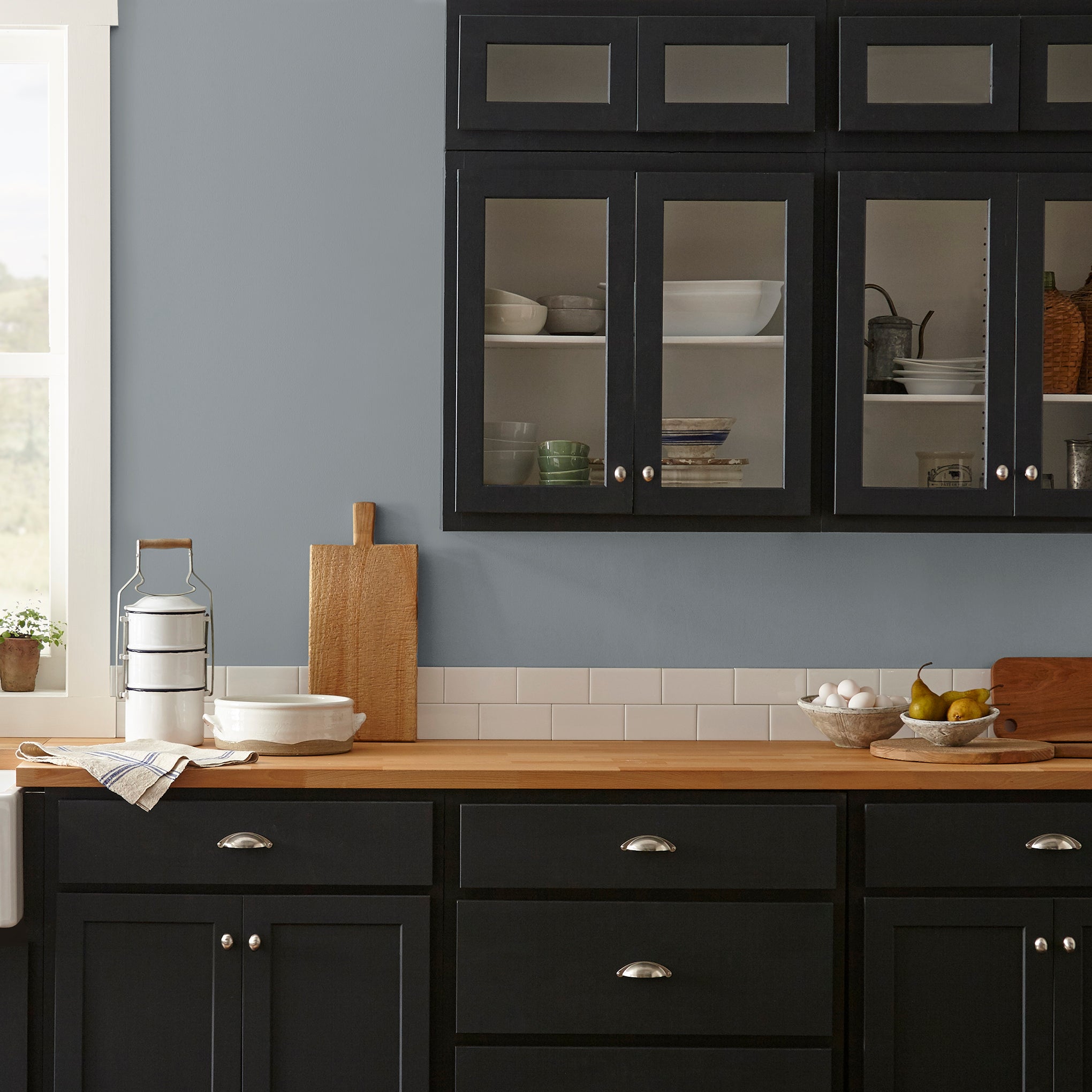 dark grey with blue undertone paint named deep rock shown painted on kitchen wall
