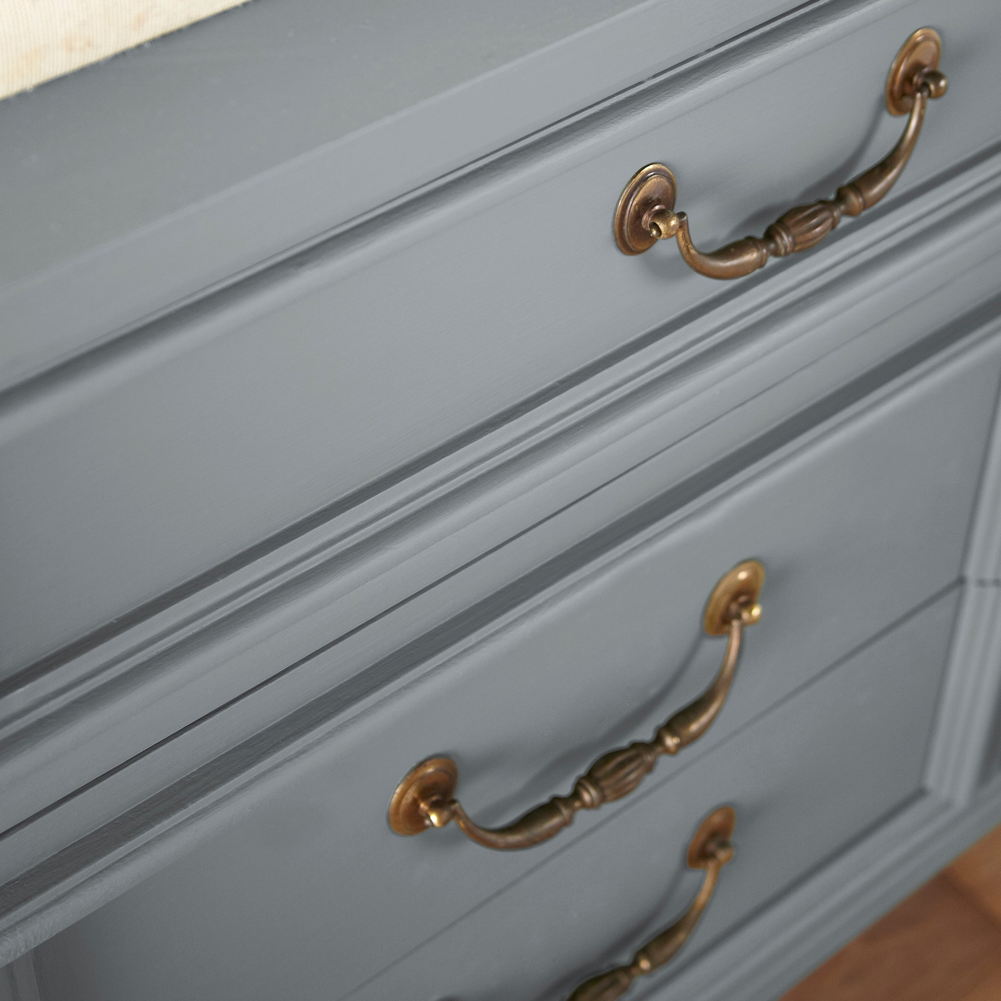 A dark gray with blue undertones door and cabinet paint named deep rock shown painted on cabinet
