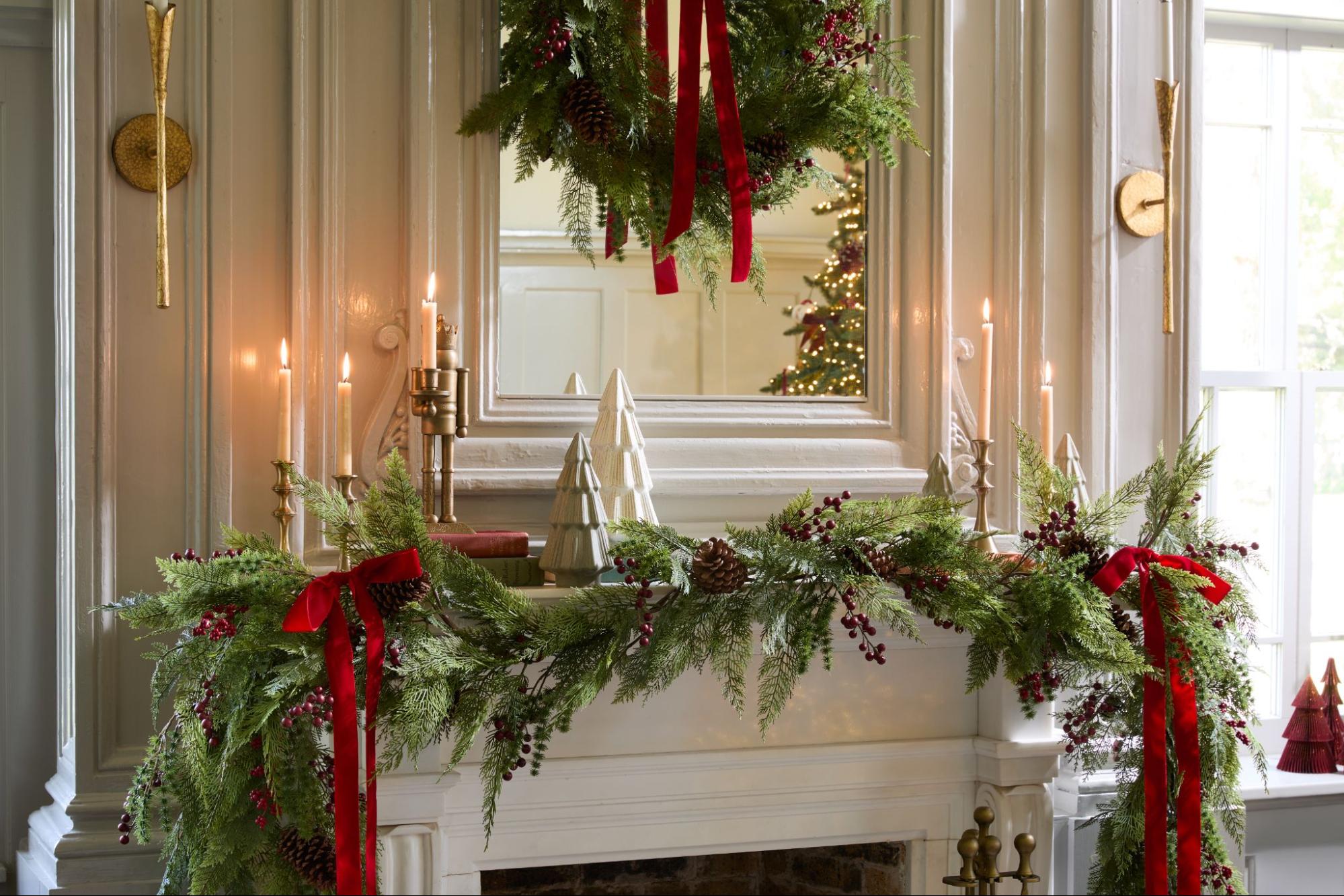 Garland, bows, and a wreath decorate a fireplace mantel at the Cottonland Castle.