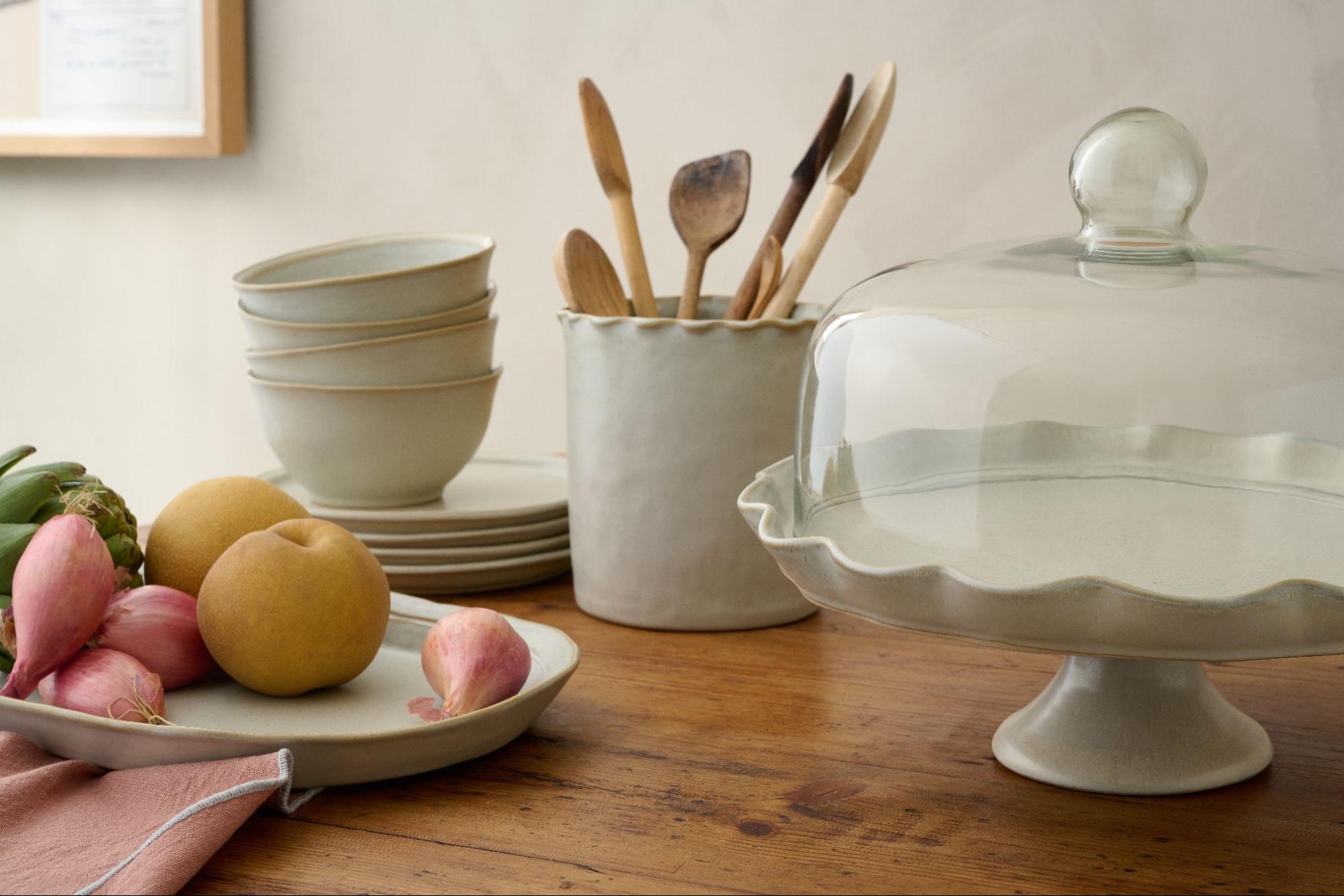 Grey-toned kitchen pieces from Magnoliass sit on a wooden tabletop.