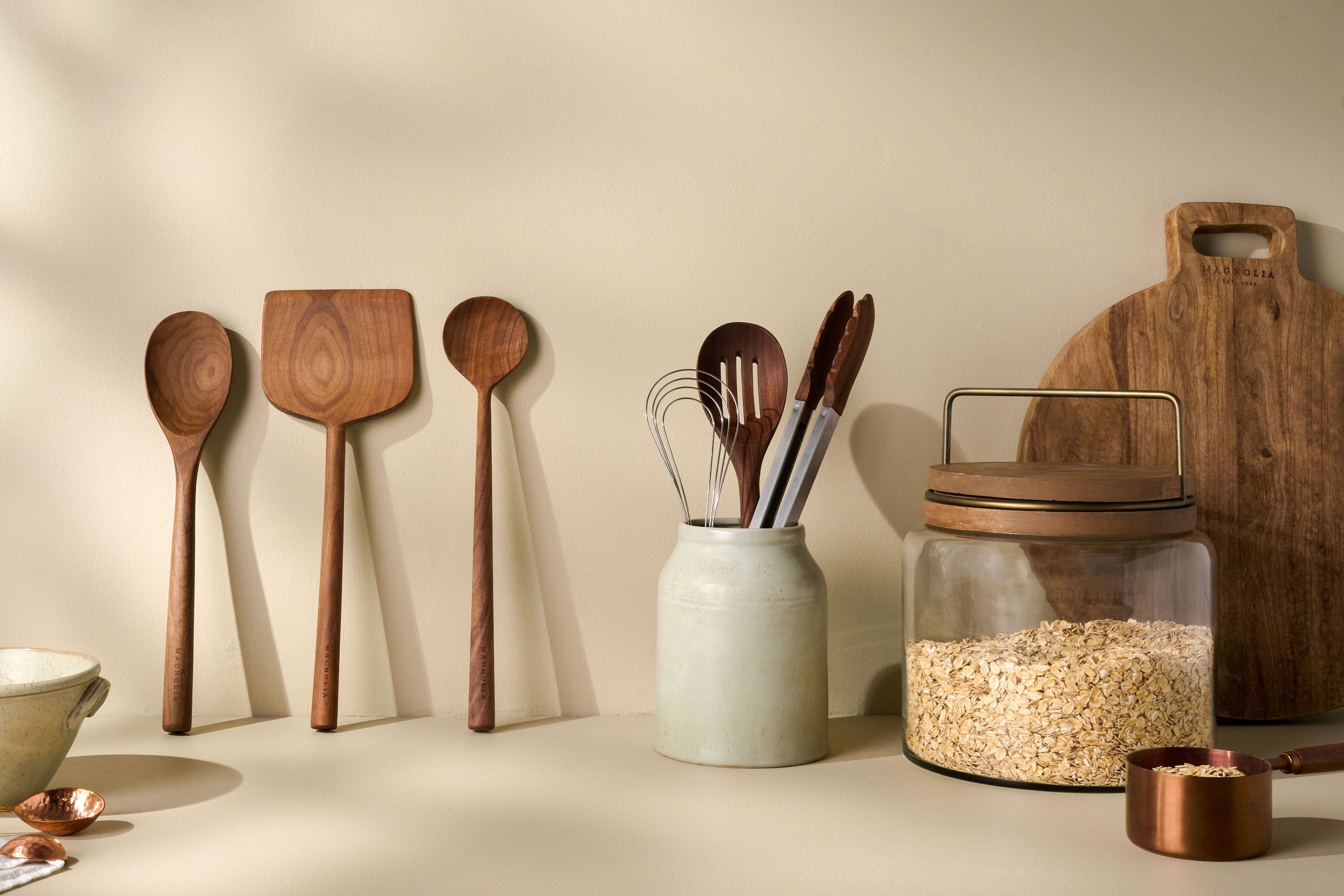 Shop kitchen utensils. Image features various wooden spoons, turners and whisks.