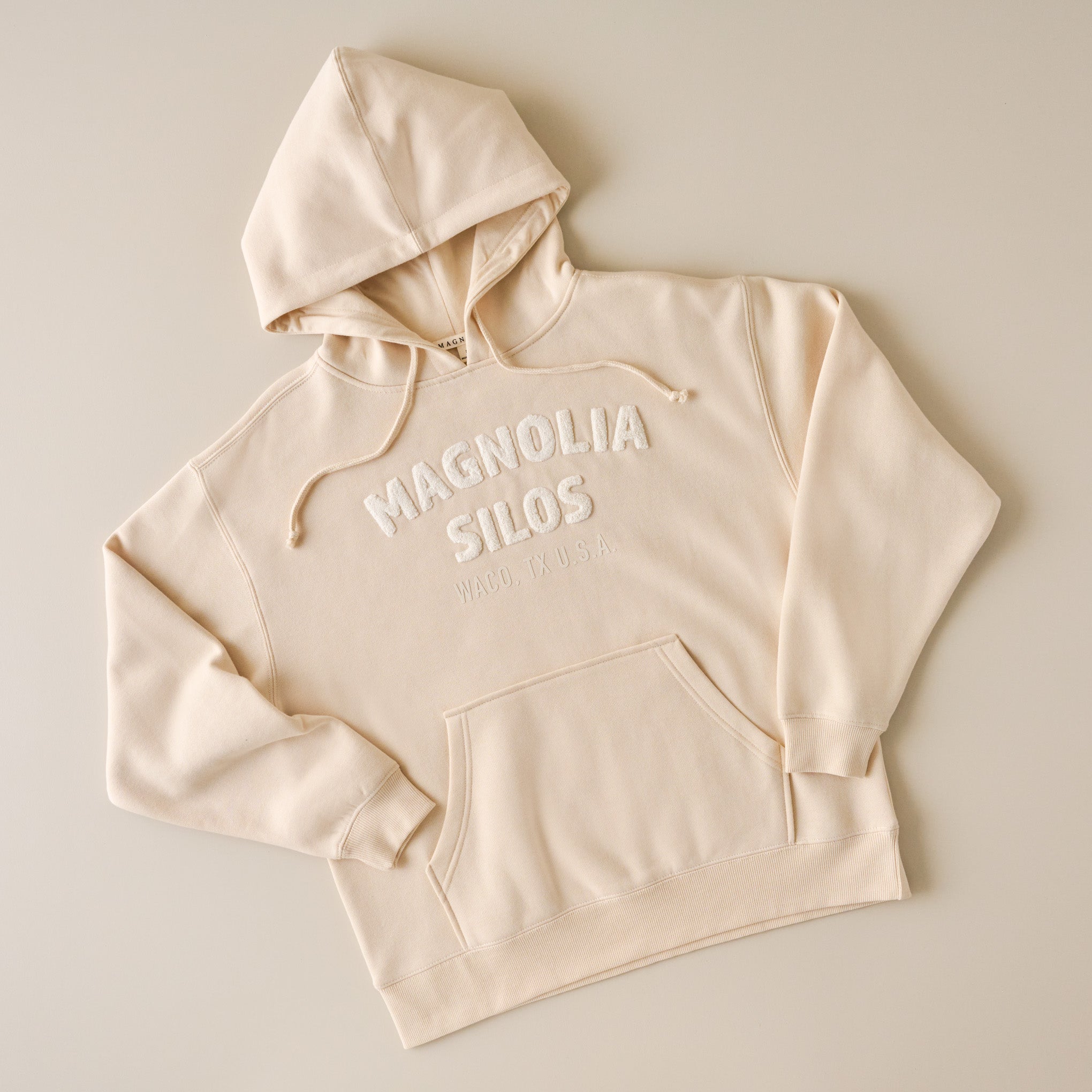 shop Magnoliass clothing. Image features burgundy crewneck sweatshirt reads Magnoliass waco, texas