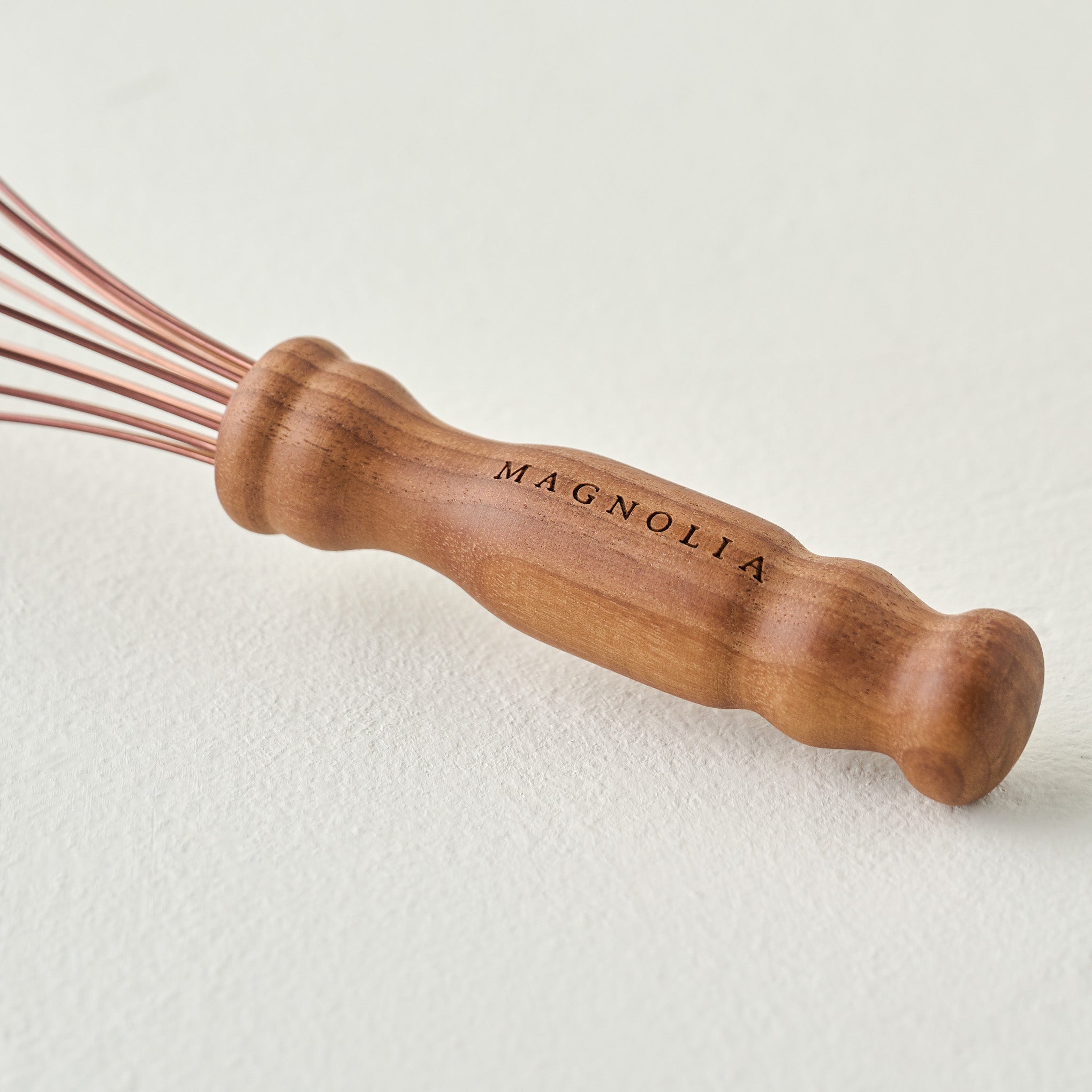 Copper and Walnut Whisk, Magnoliass branded handle up close