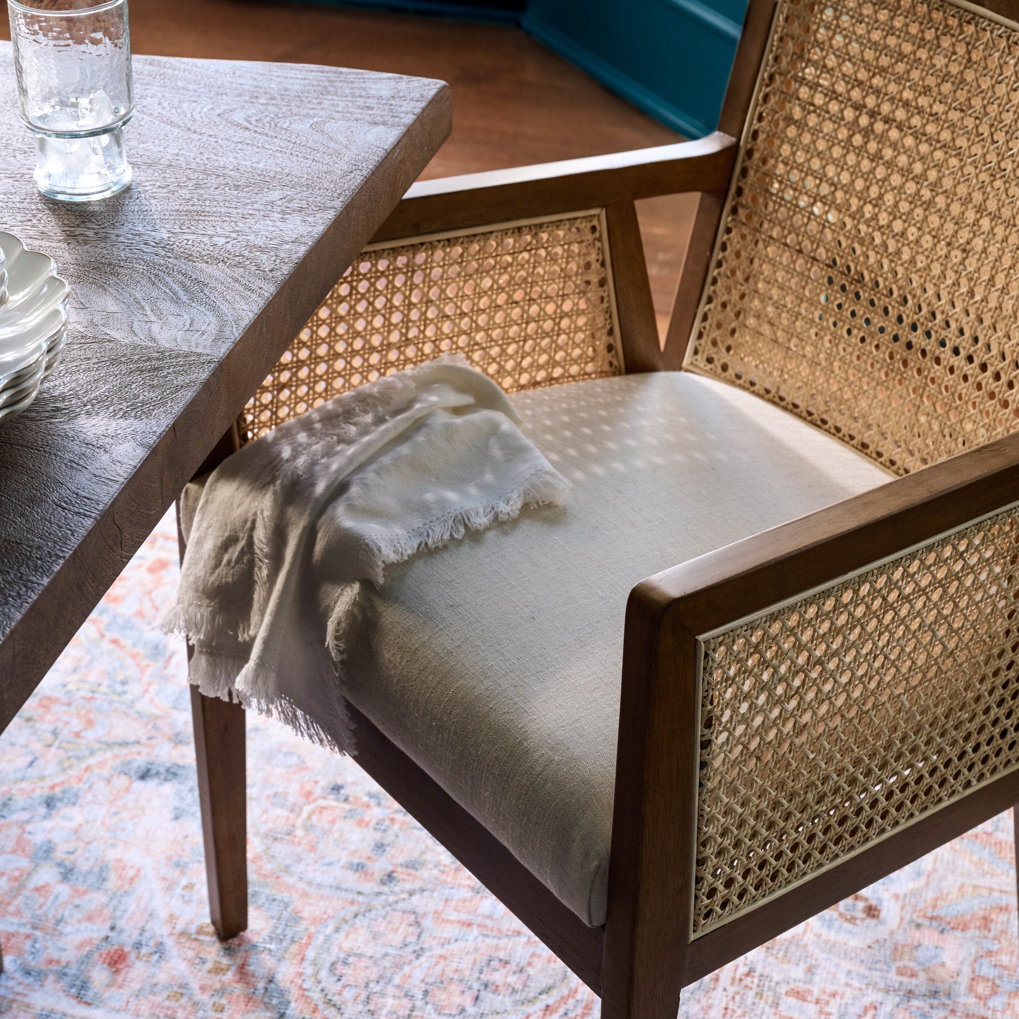 Lita Dining Armchair at a table with a napkin on the chair seat