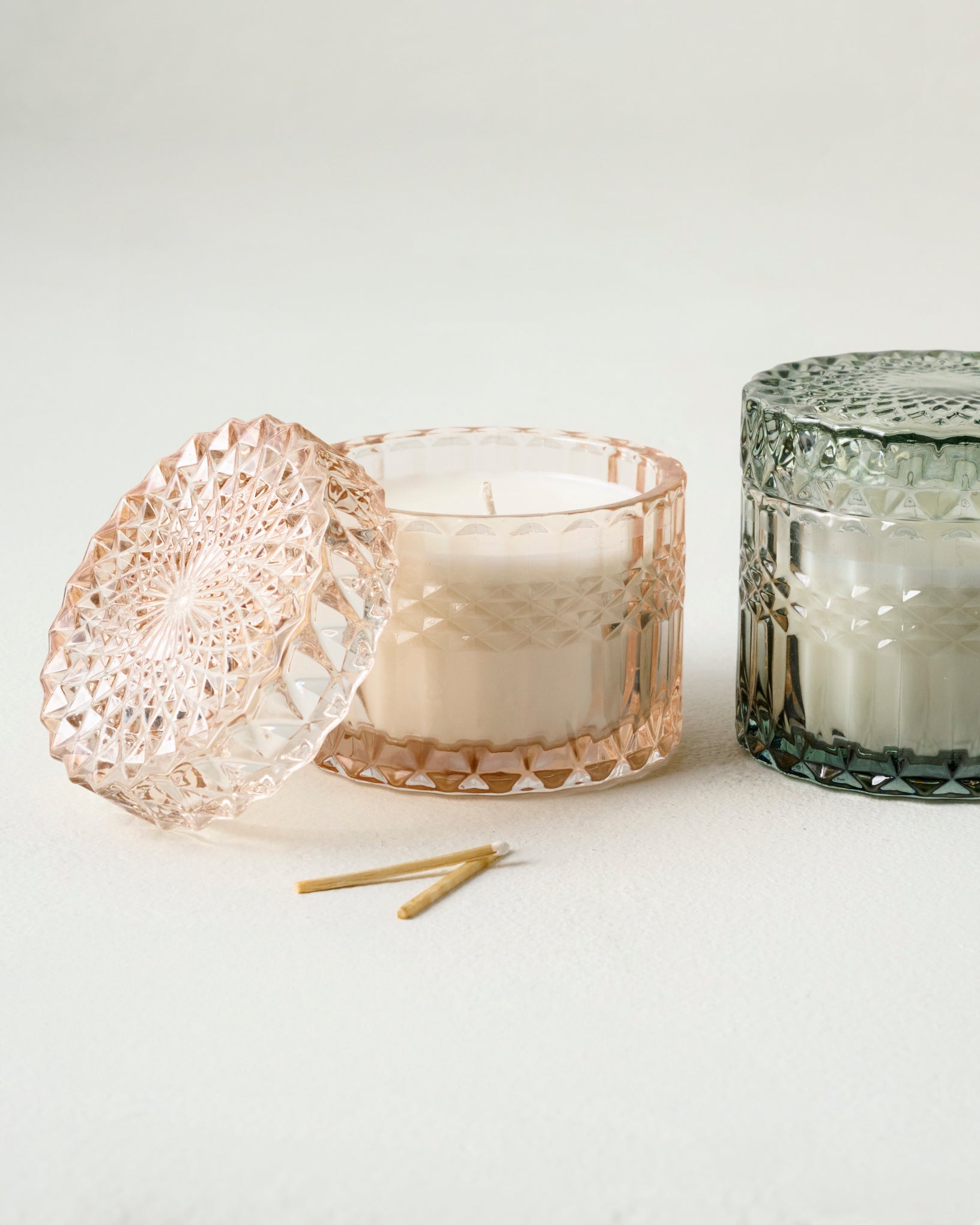 Magnoliass Morning Light Glass Candle shown with another cut glass candle