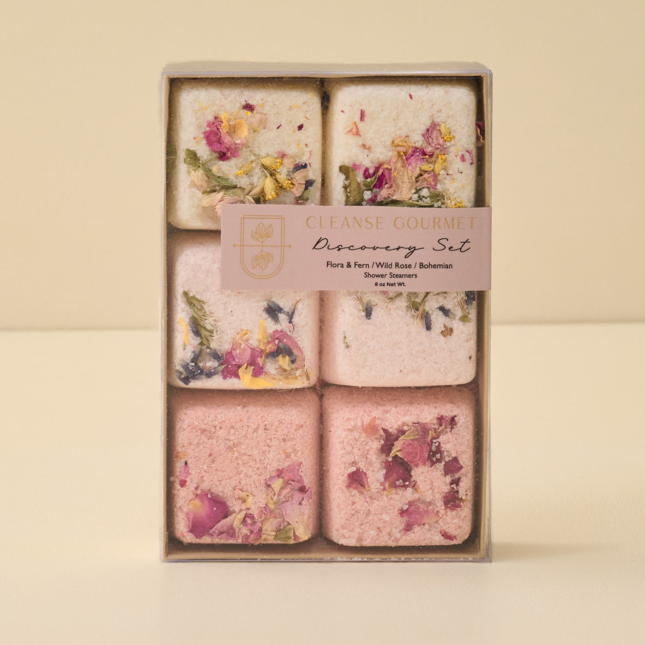 Set of six floral soap bars in a decorative box on a beige background