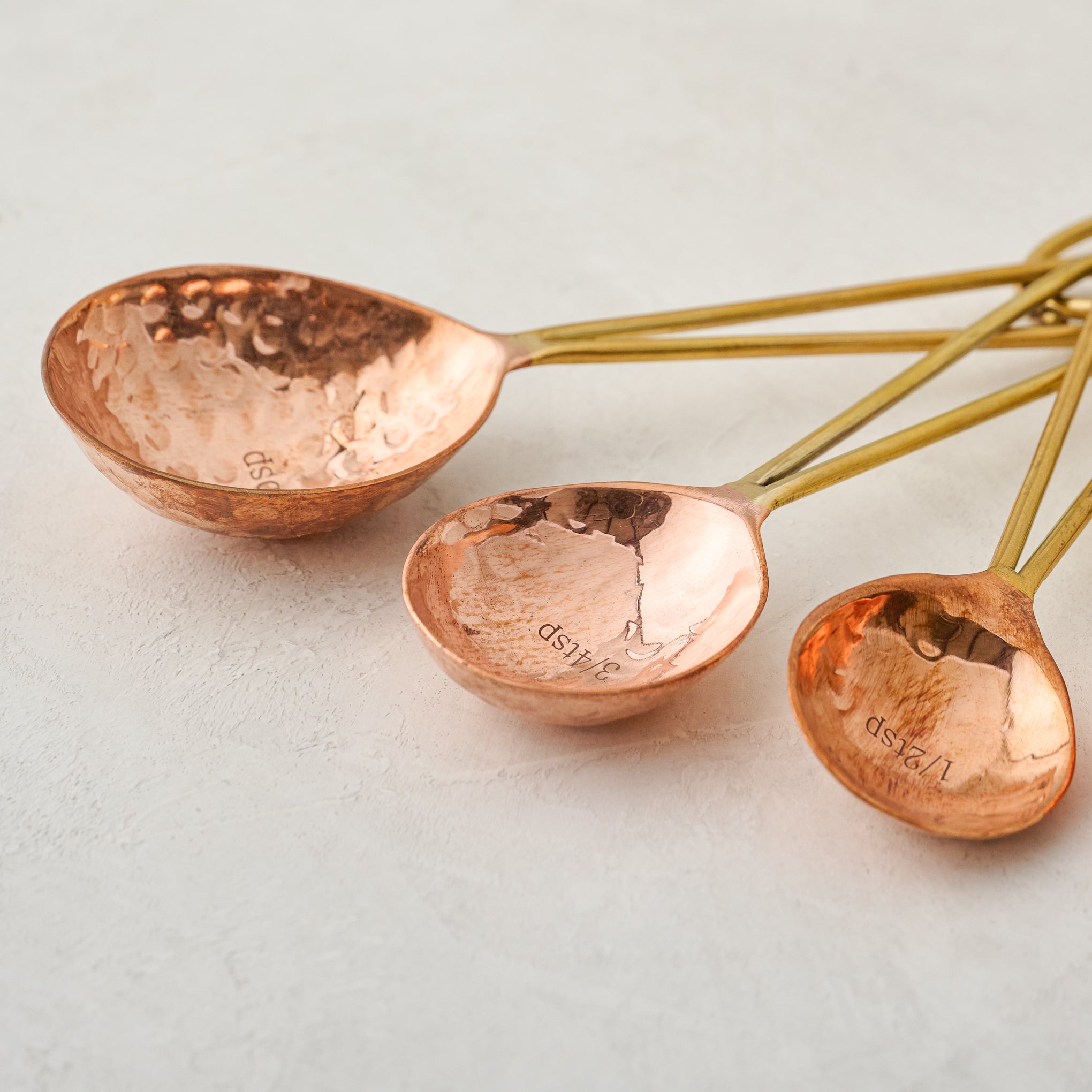 close up view of Hammered Copper and Gold Measuring Spoons