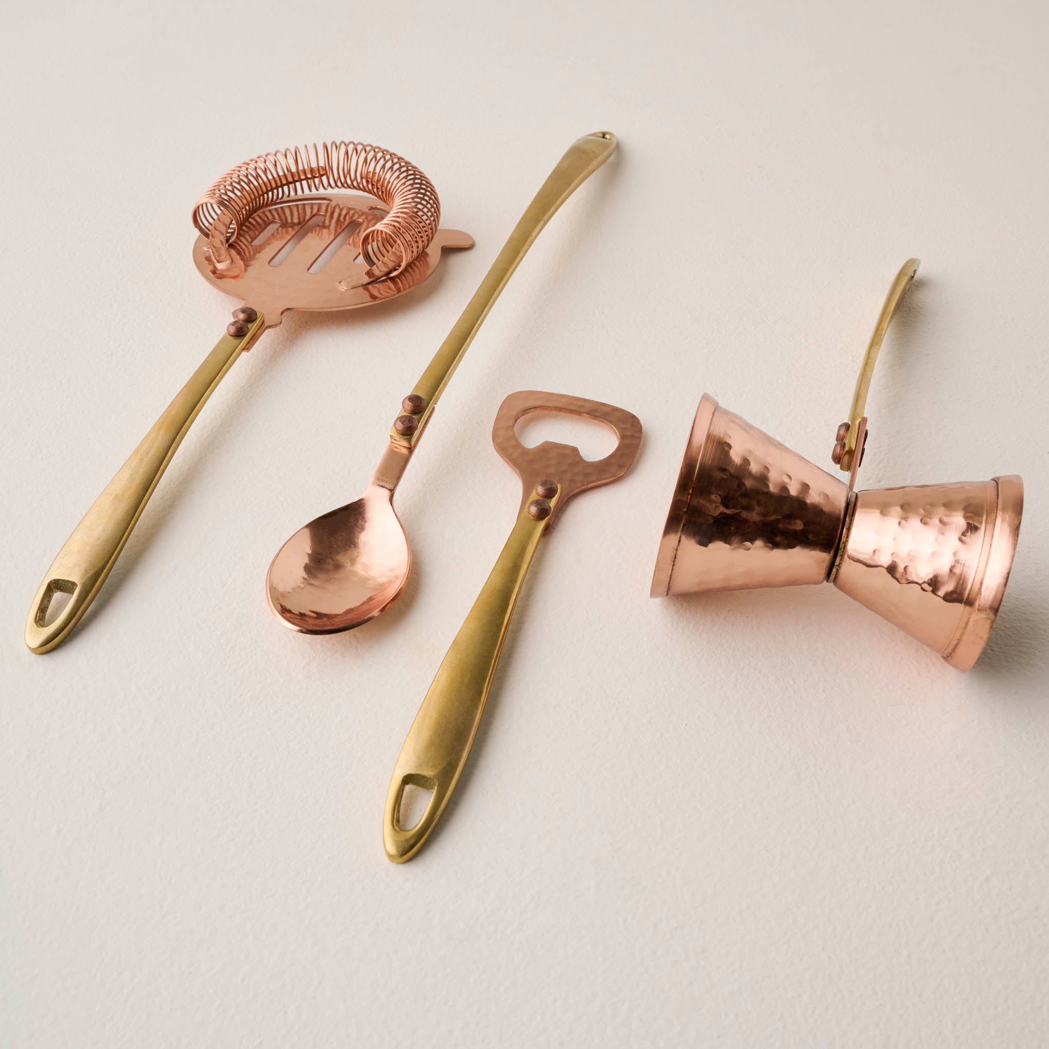 Hammered Copper and Gold Stirring Spoon shown with other bar tools