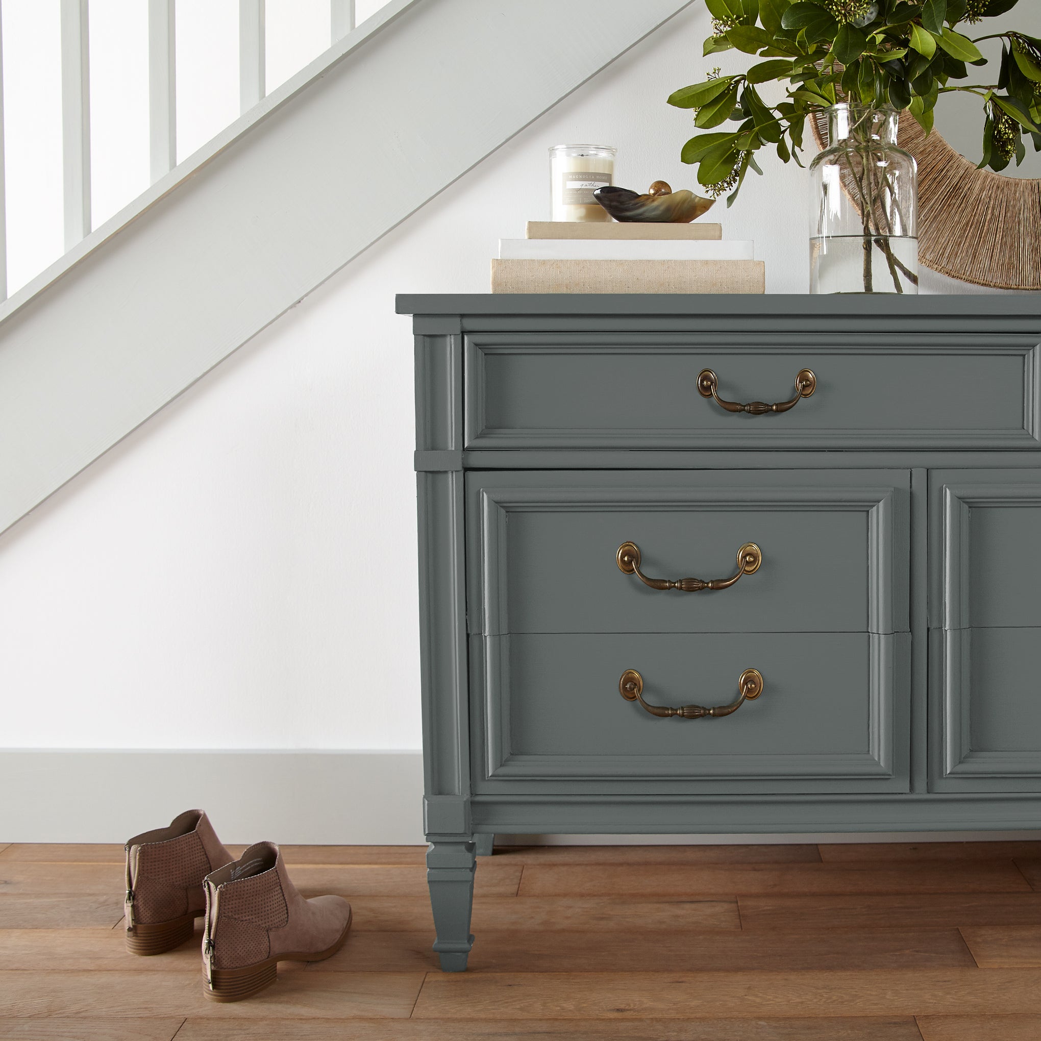 Ridge Rock paint shown on vintage-inspired console table with stacked books on top and florals inside vase