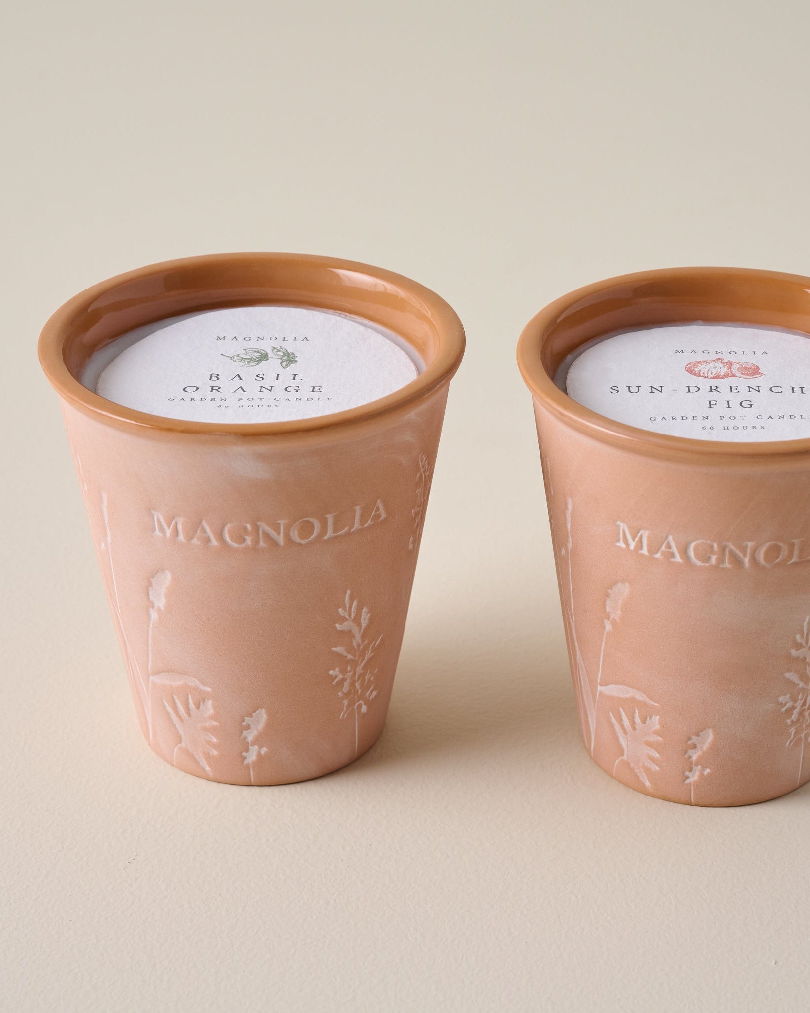 Magnoliass Basil Orange Garden Pot Candle shown with Sun Drenched Fig Candle