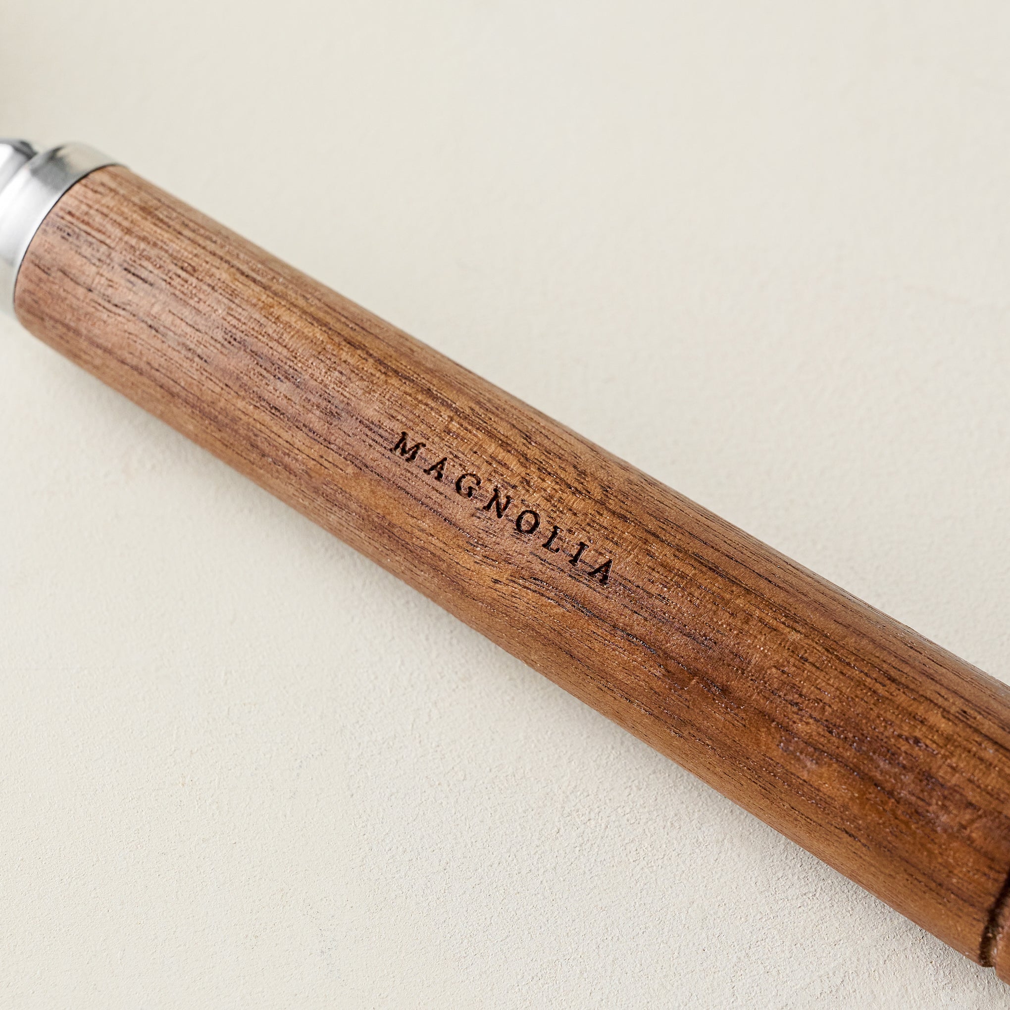 Gristmill Collection Walnut Ice Cream Scoop close up of handle showing Magnoliass embossing
