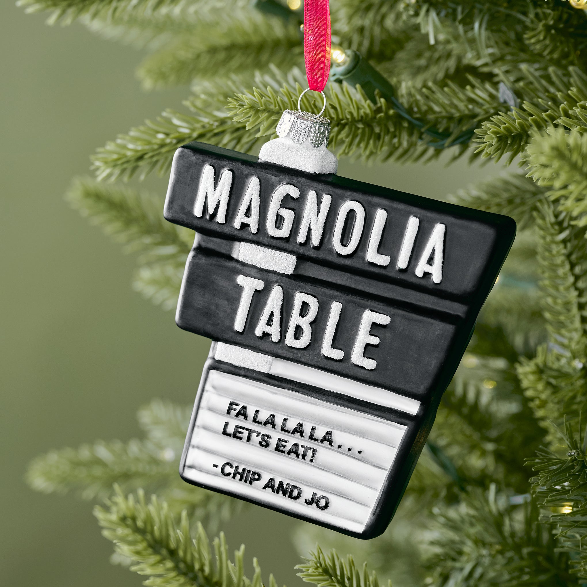 Magnoliass Table Blown Glass Ornament shown on tree