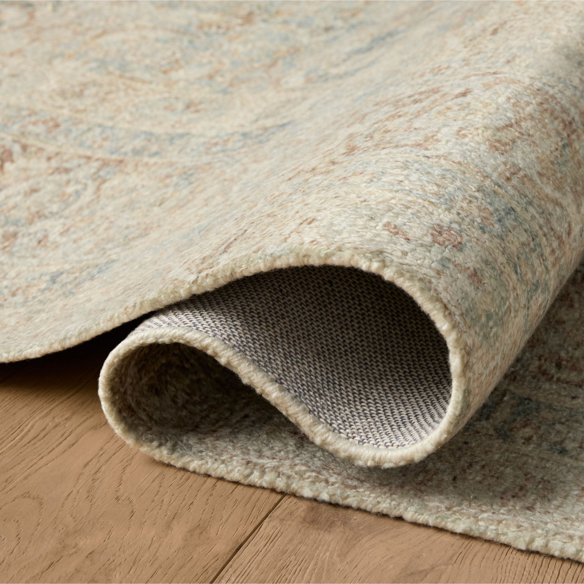 Wimberly Sky Copper Rug shown rolled/folded
