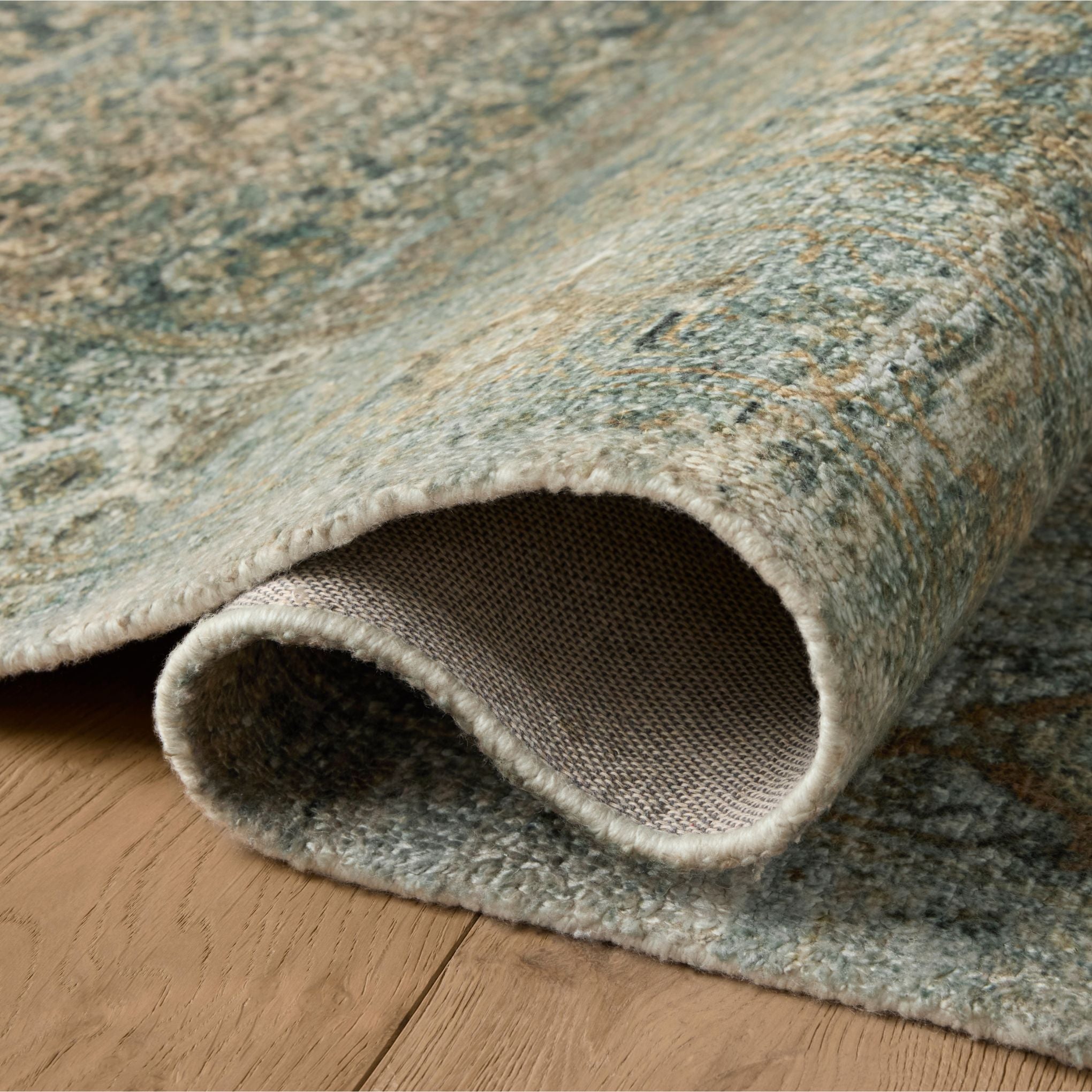 Wimberly Lagoon Wheat Rug shown rolled/flipped