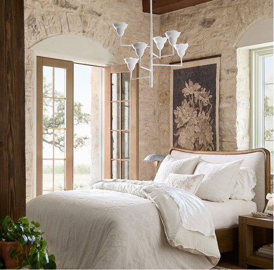 Luxurious bedroom with stone walls, large bed, and decorative elements.