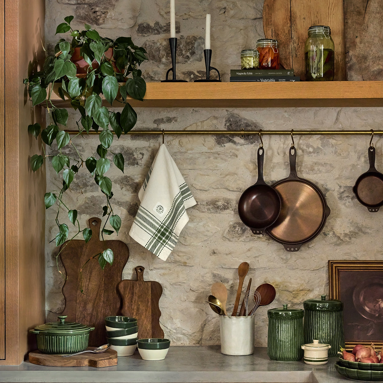 Kitchen with hanging pots, stone wall, and various kitchen items.  Shop the cottage kitchen collection.