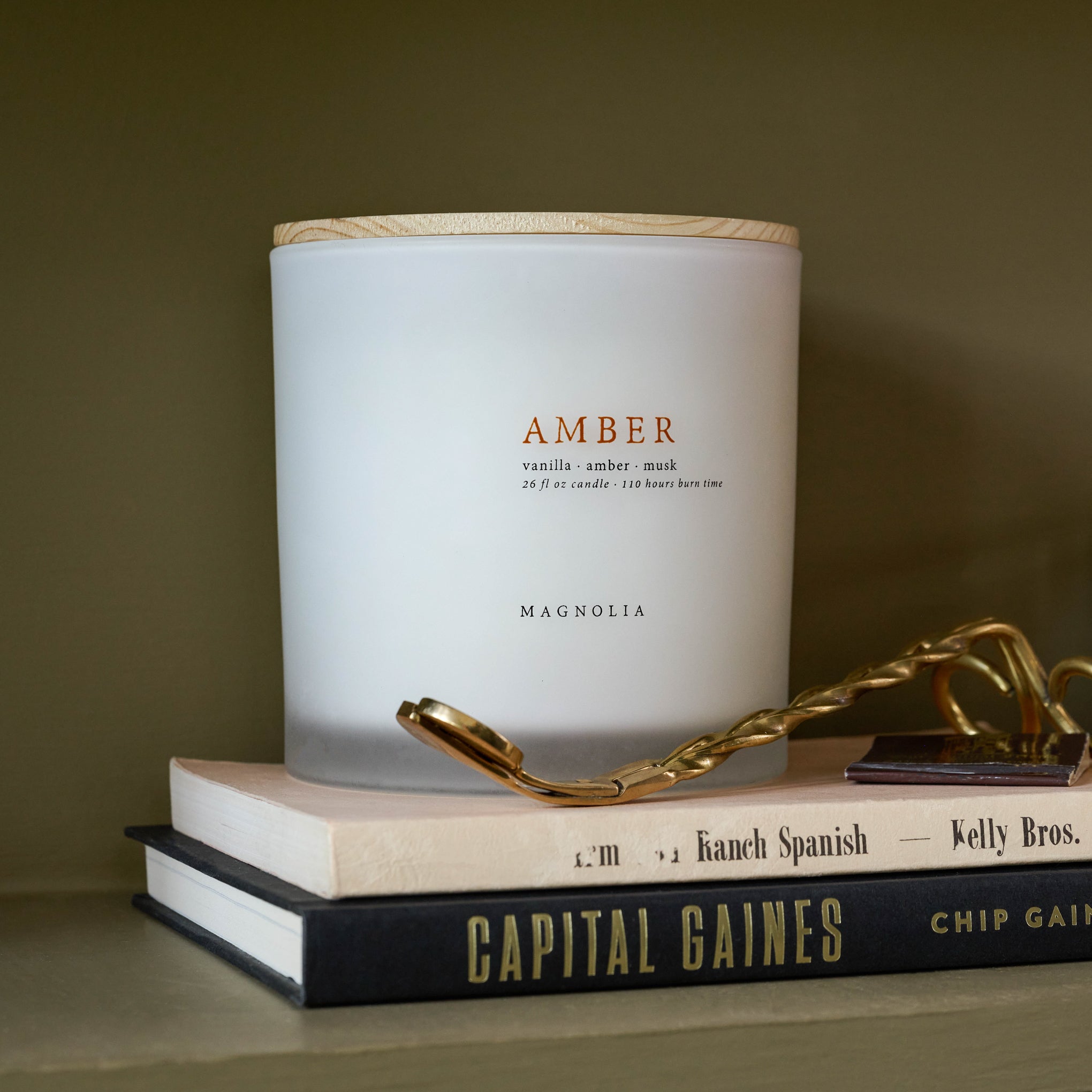 Magnoliass Amber Candle on books