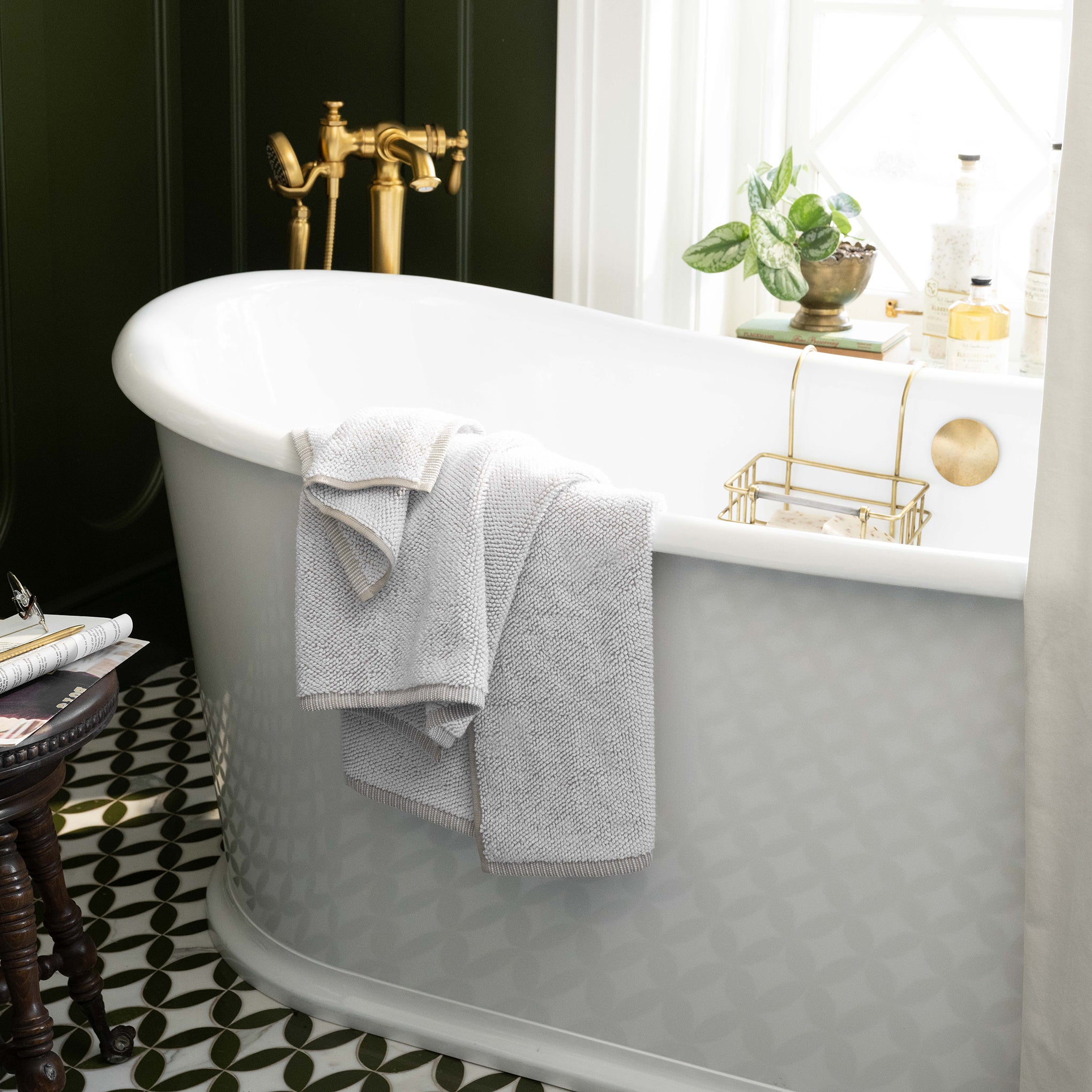 Linen assisi textured towel draped over a bathtub