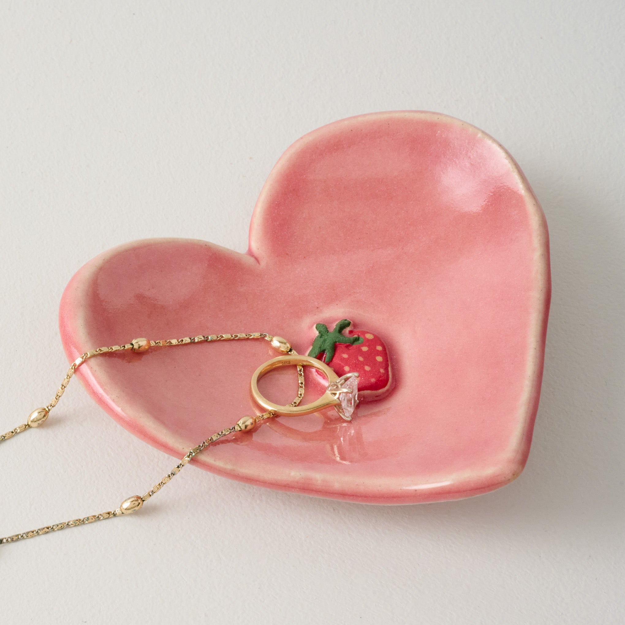 Black Oak Artisan Strawberry Heart Trinket Dish shown with ring and necklace