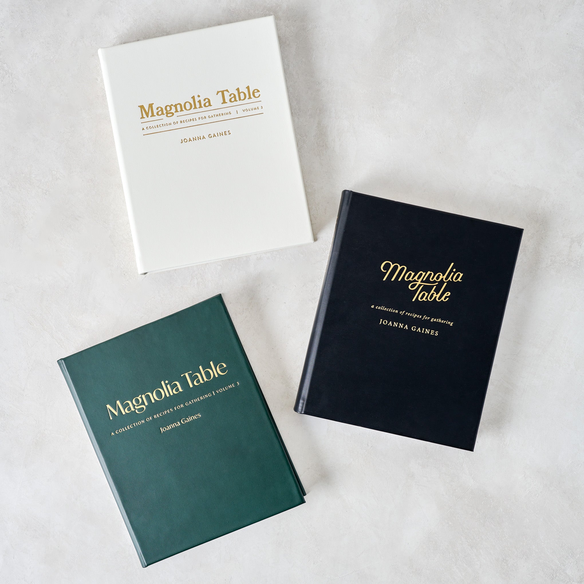 Leather Bound Magnoliass Table Cookbook Volume 3 shown with other volumes