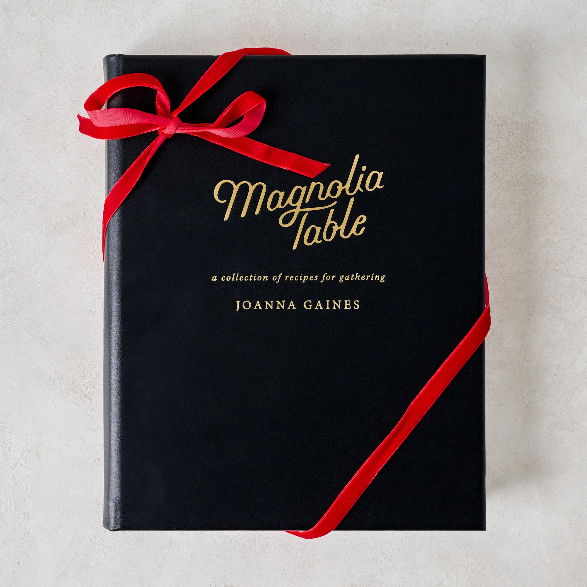 Leather Bound Magnoliass Table Cookbook with ribbon around