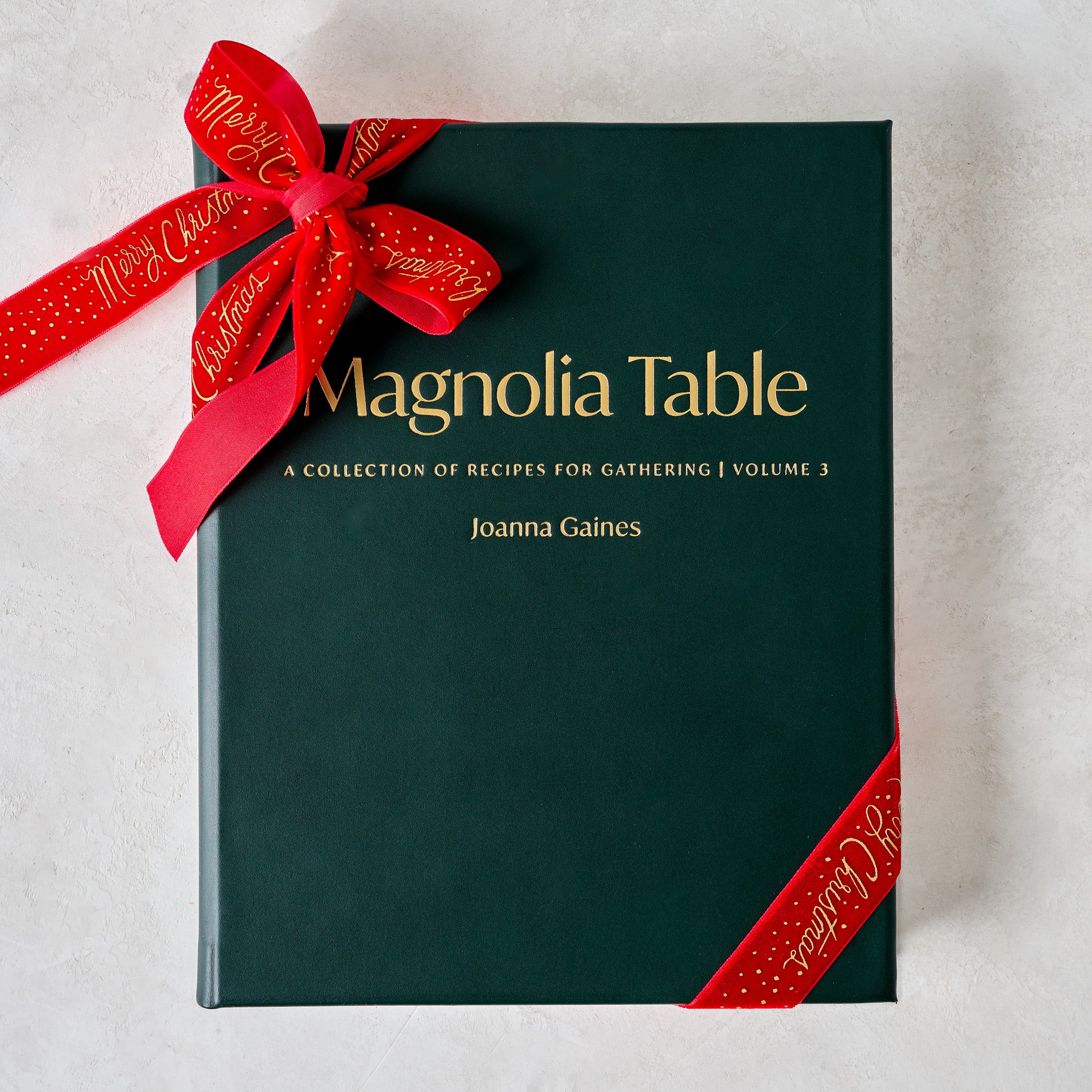 Leather Bound Magnoliass Table Cookbook Volume 3 shown with ribbon