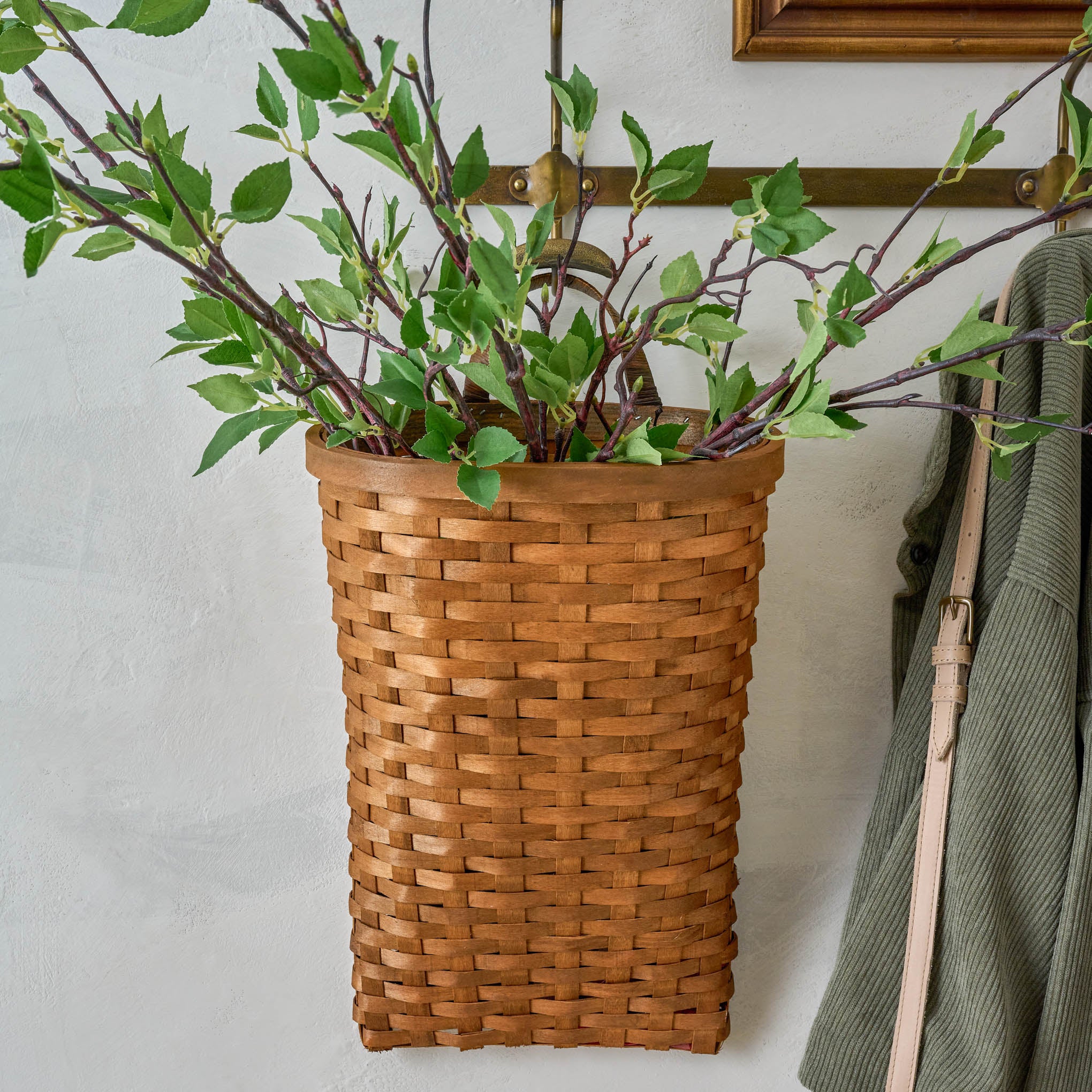 Warren Hand Woven Wall Basket with greenery inside