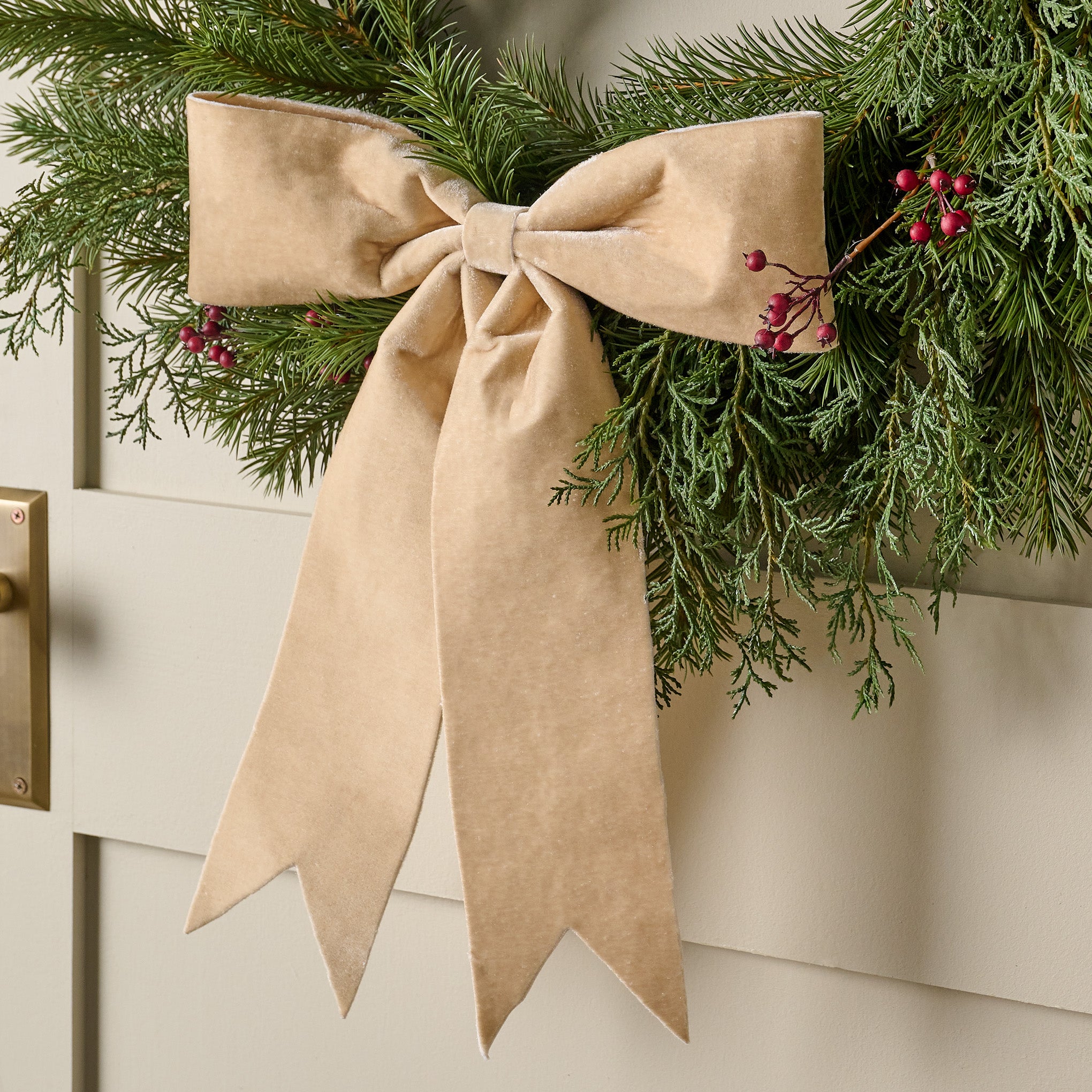 Cream Bountiful Bow Tree Topper shown on wreath