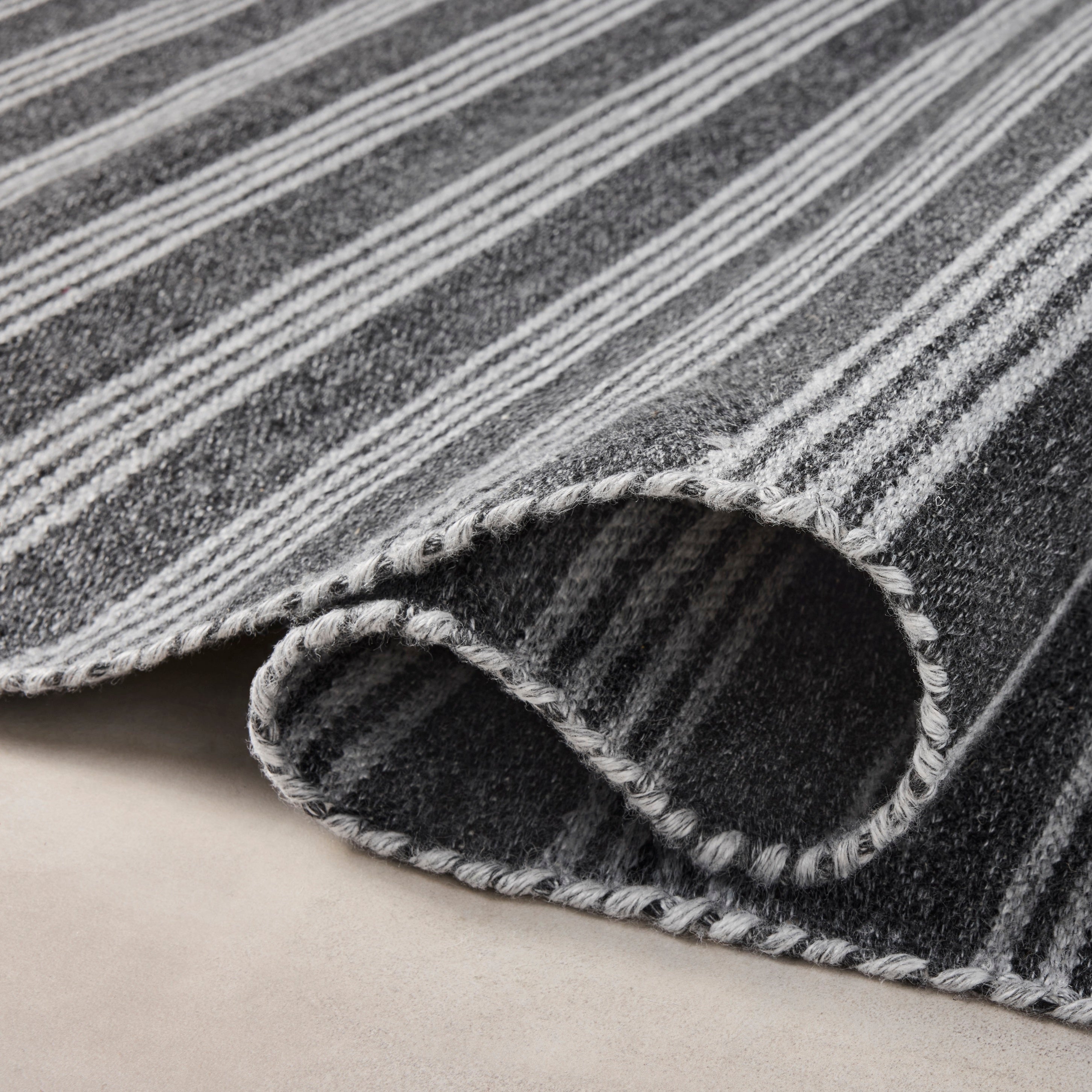 Charlie Charcoal Grey Rug close up of rolled rug