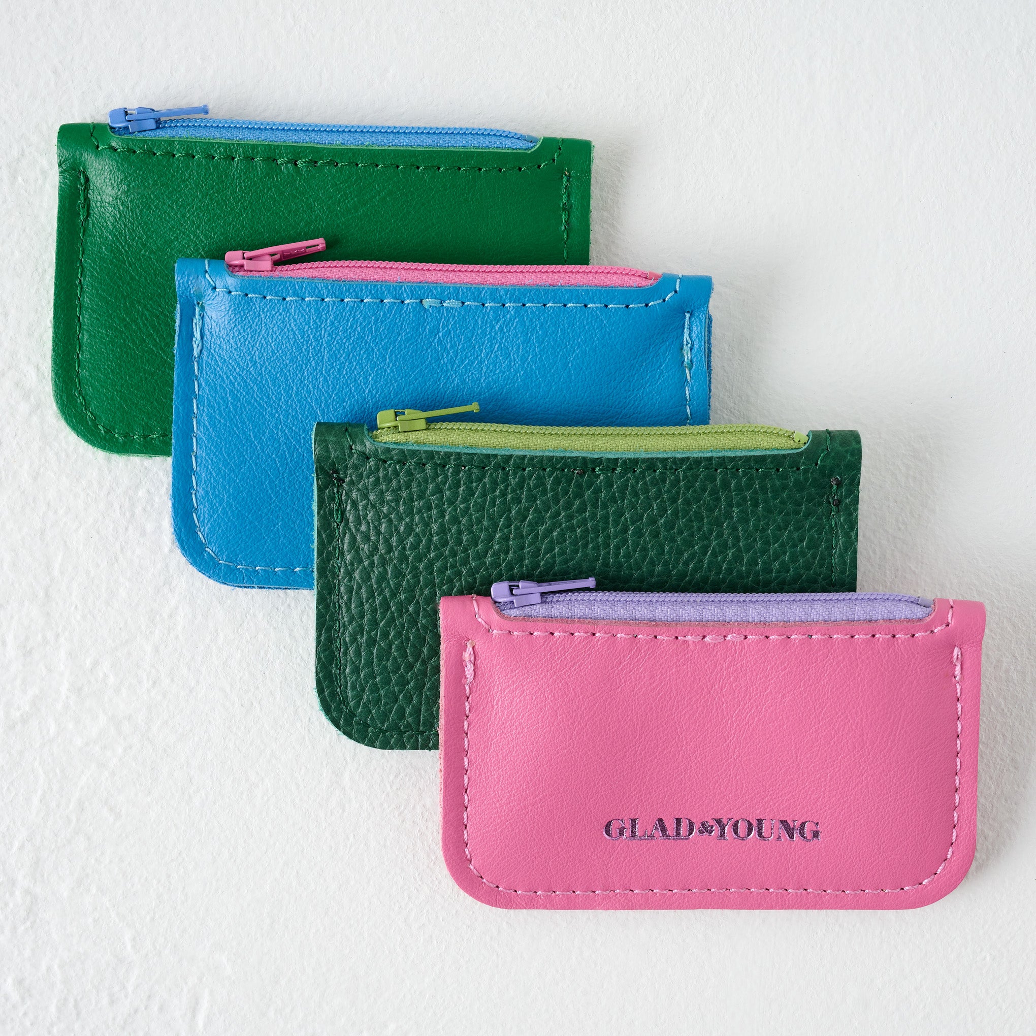 Kelly Green Small Change Wallet shown with other wallets