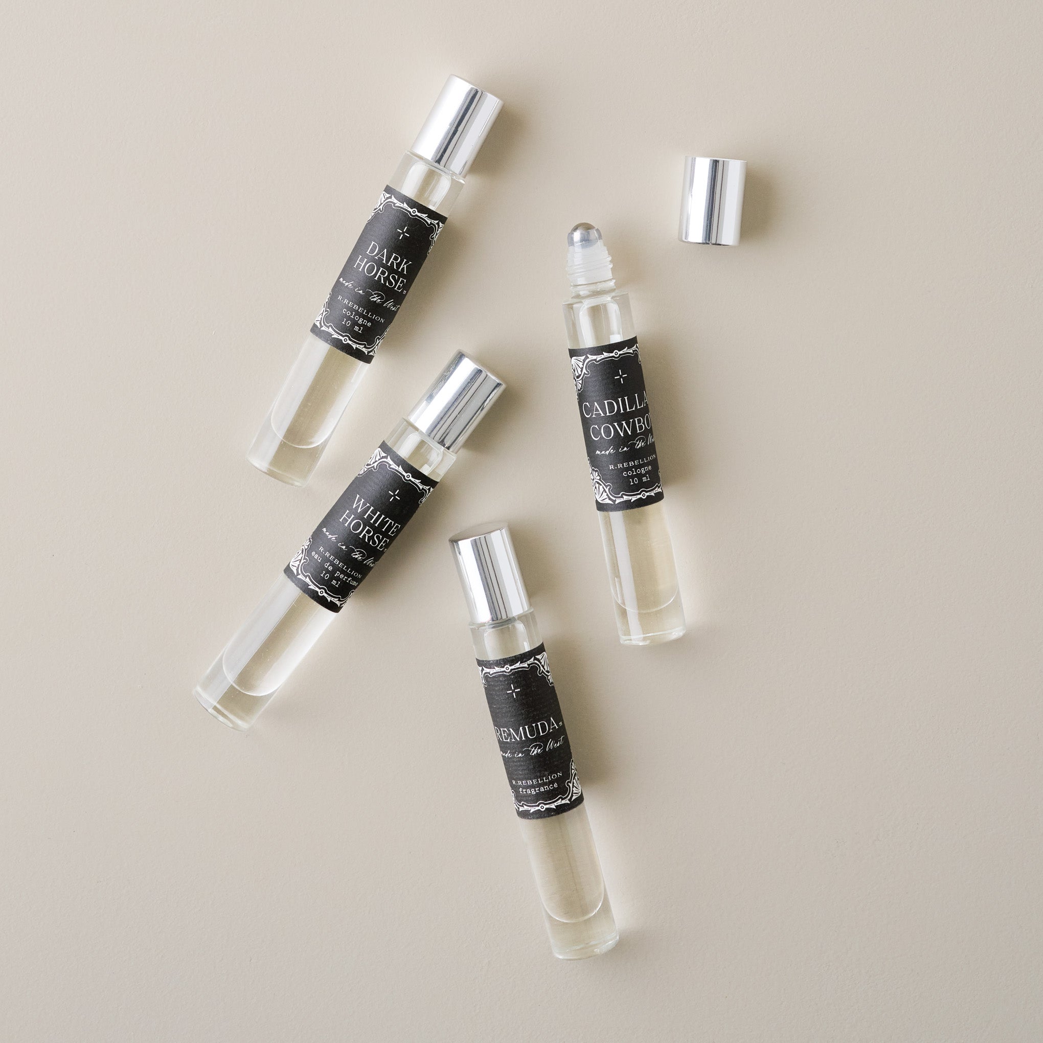 Cadillac Cowboy Roll On Cologne Oil shown with other colognes