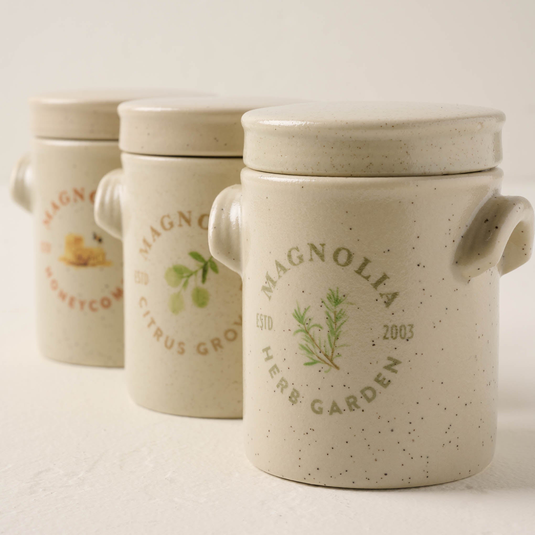 herb garden candle lined up with honeycomb and citrus grove candles
