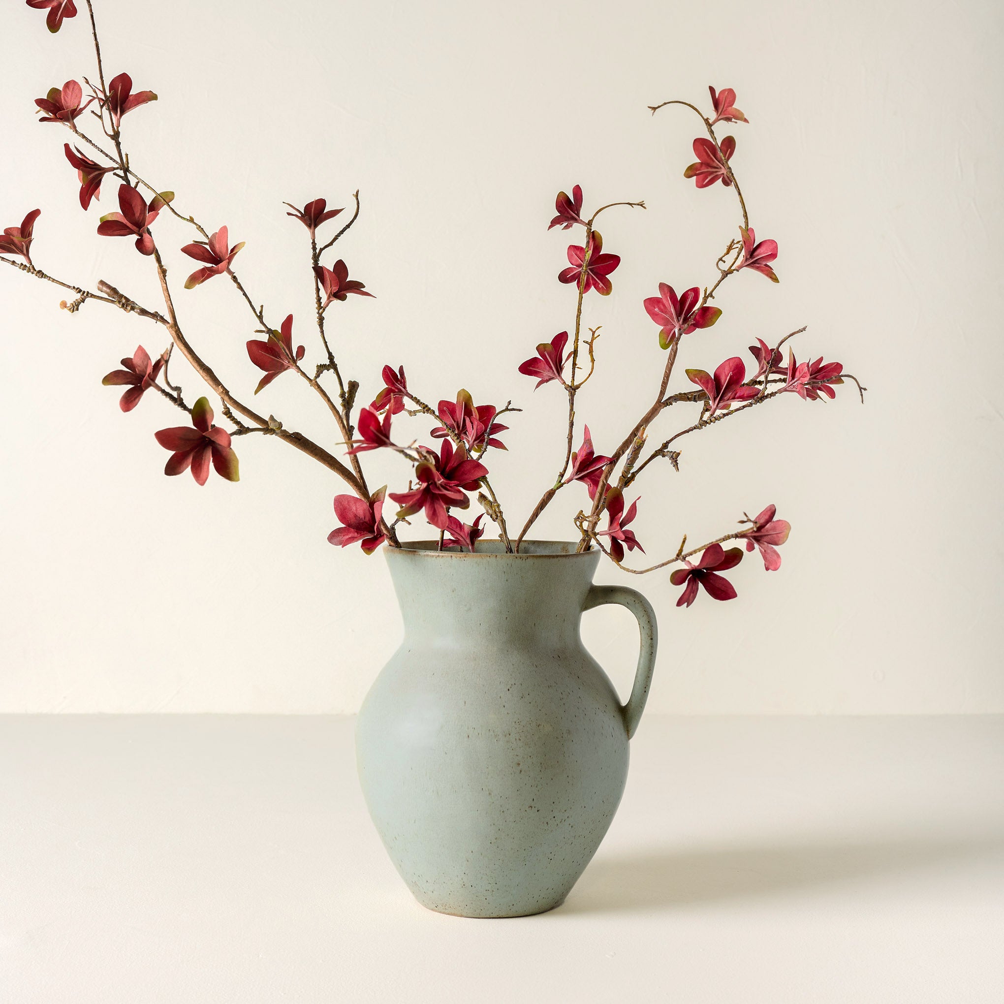 Large Magnoliass Bloom Spray shown in green vase