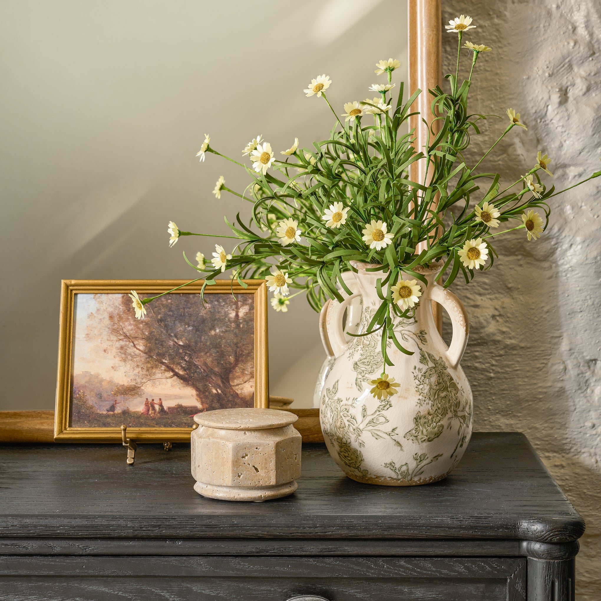 framed art set in brass shelf easel on dresser