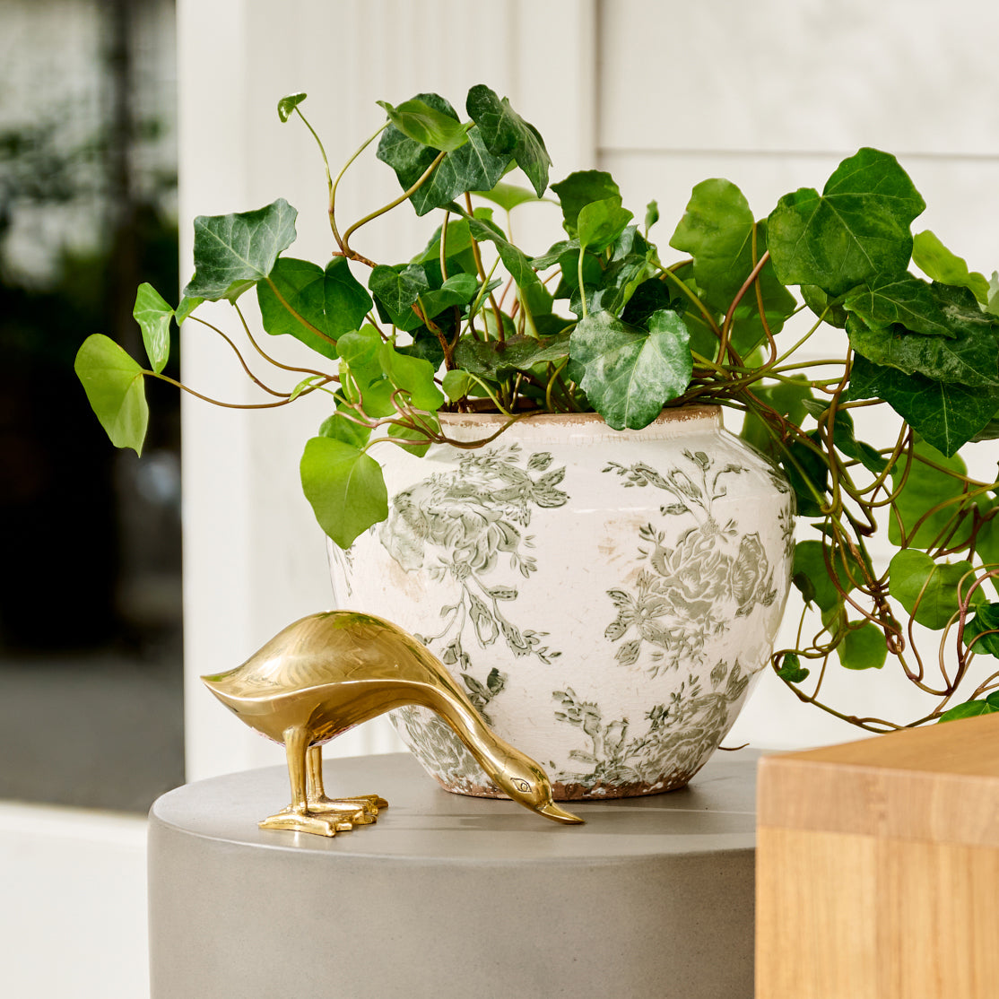 small Green and White Distressed Floral Vase shown outside