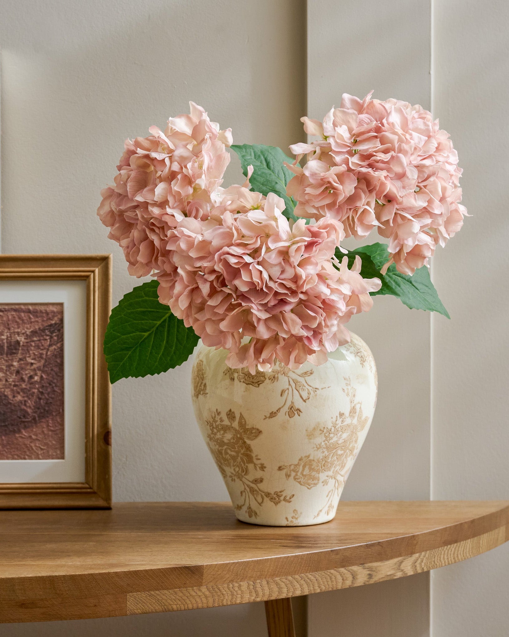 Taupe Distressed Floral Vase paired with hydrangeas on top of console table 