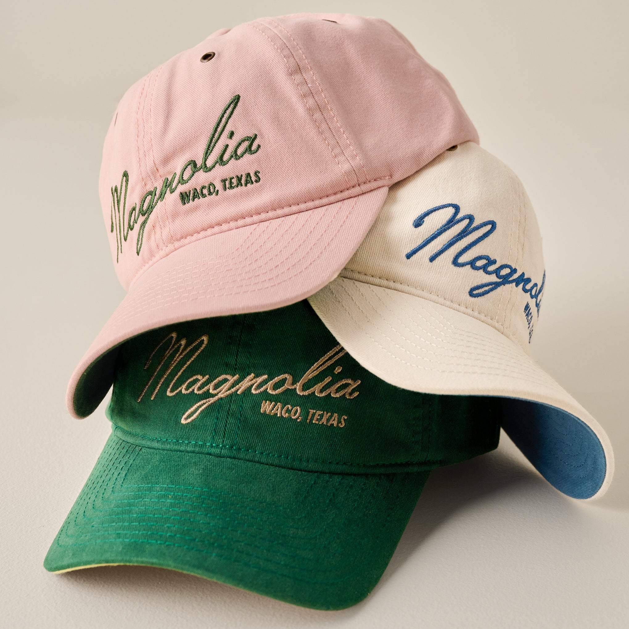 Magnoliass Embroidered Script Blush Hat shown with green and cream hats
