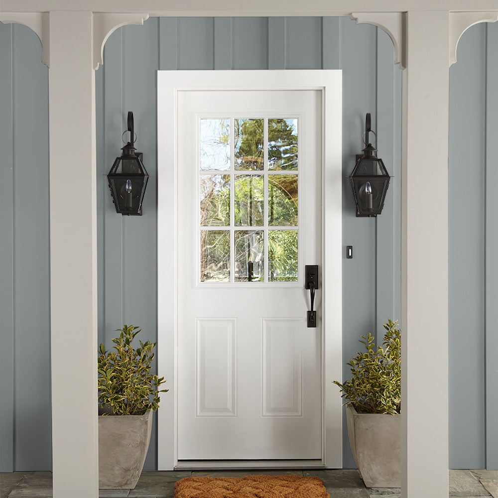 neutral grey with a tinge of blue paint color named tranquil waters shown painted on exterior siding