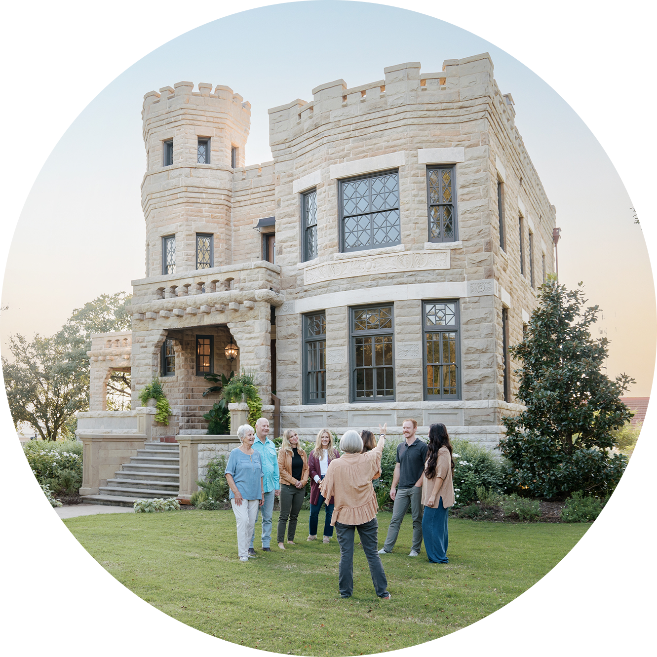 Group of people standing in front of a stone castle for the Magnoliass Castle Tour.