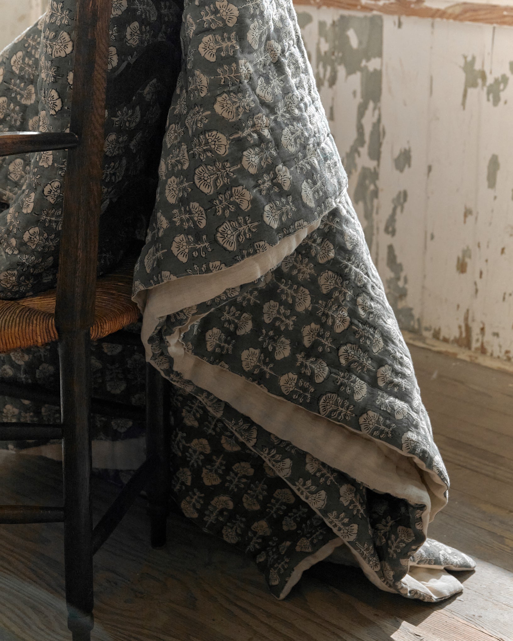 Flora Block Print Quilt - Silver Blue close up hanging off chair