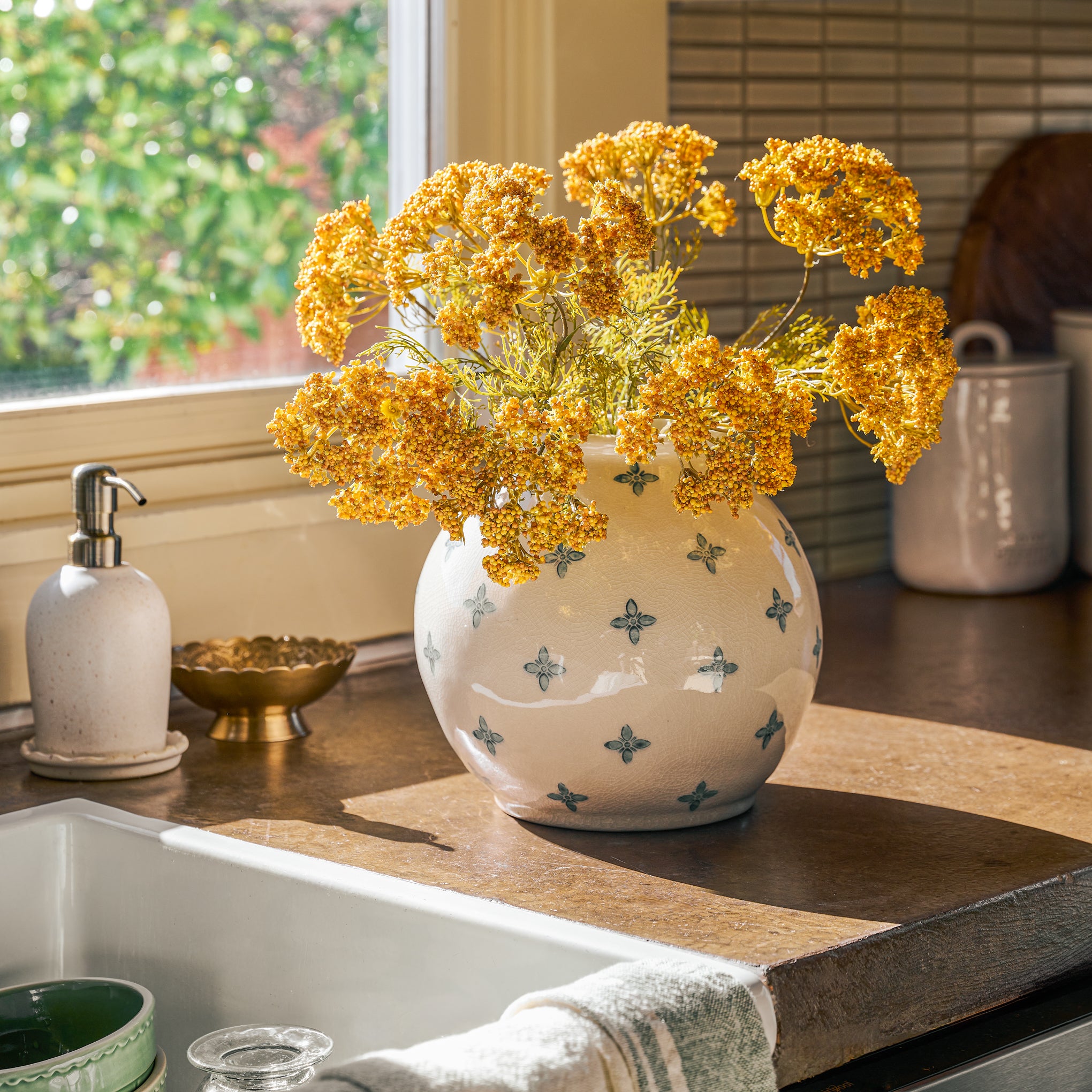 Vintage Inspired Ceramic Vase with yellow faux florals on a kitchen counter