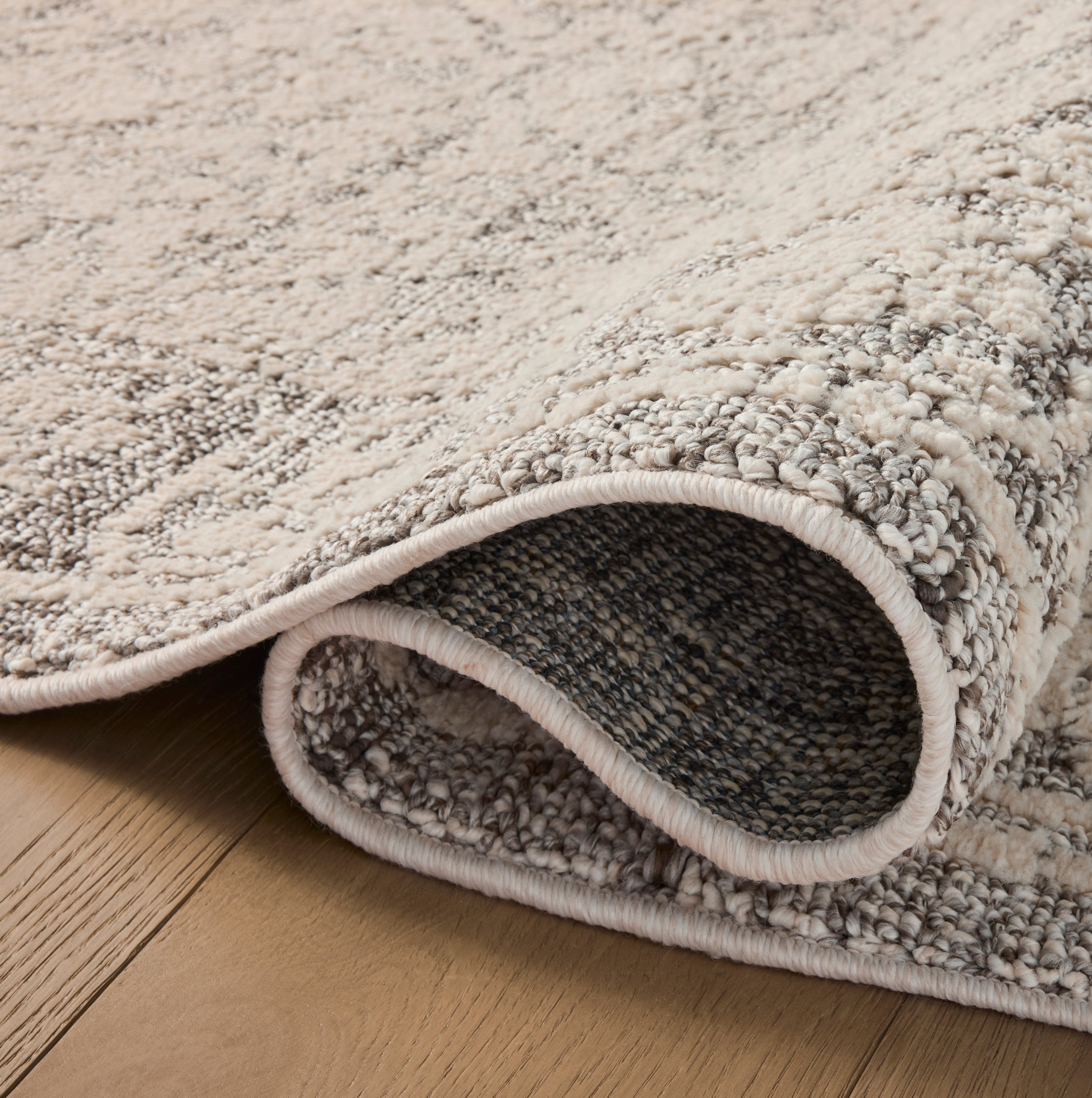 Gigi Ivory Stone Rug close up of rolled rug