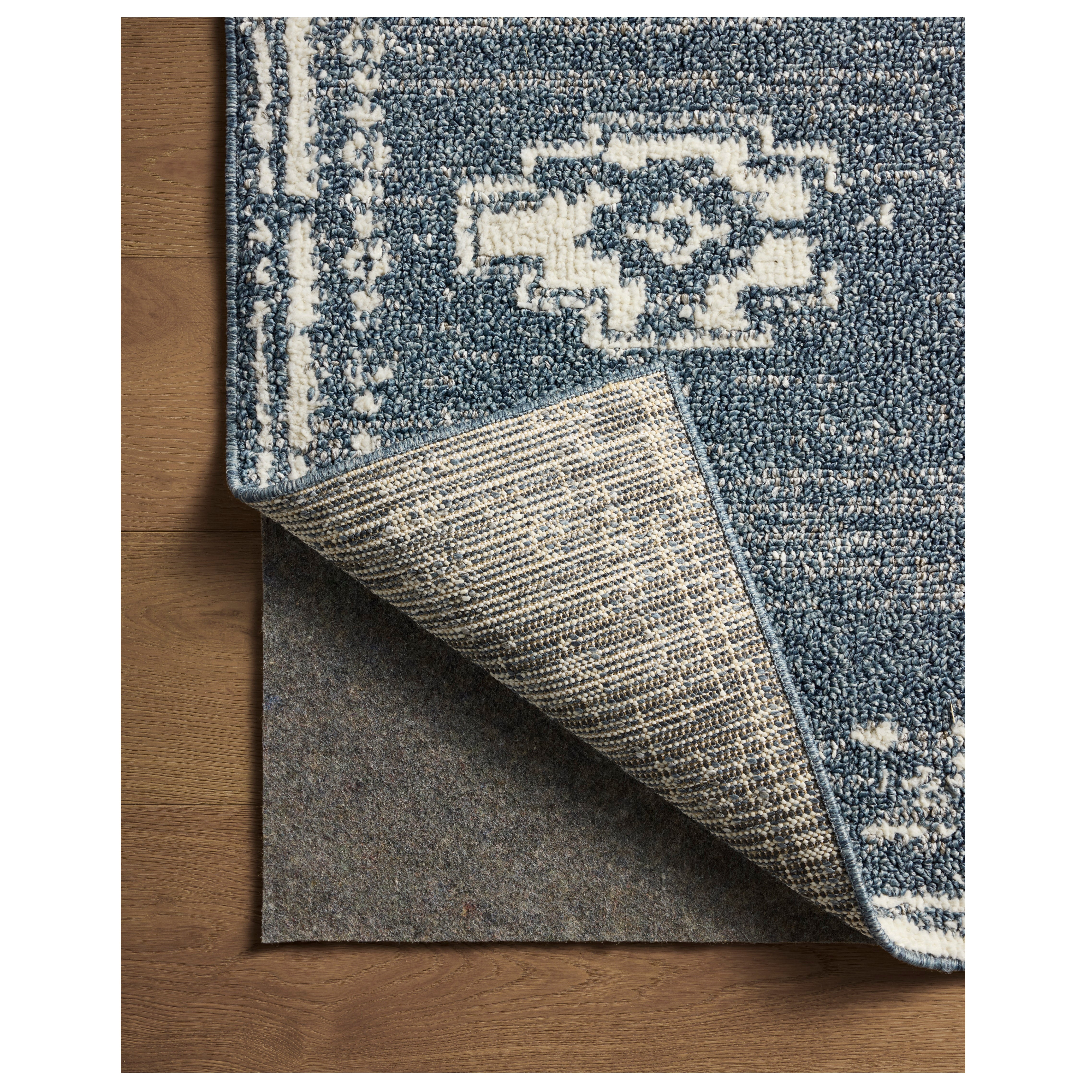 Gigi Denim Ivory Rug close up of corner folded back
