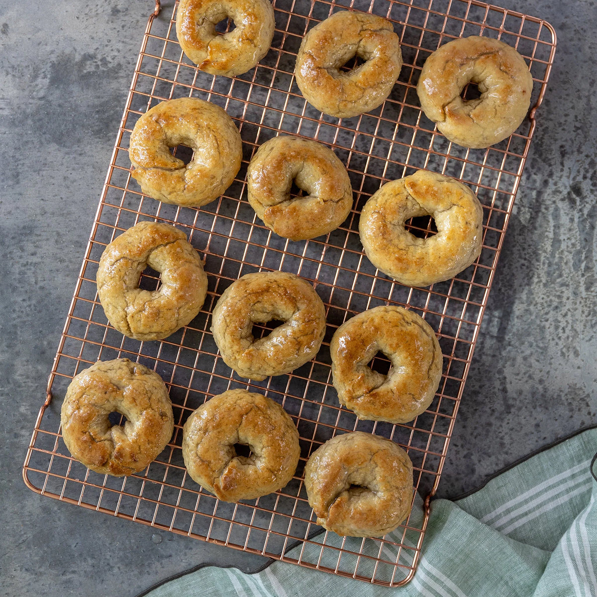 Syrian Donuts on a cooling rack with a gray background.