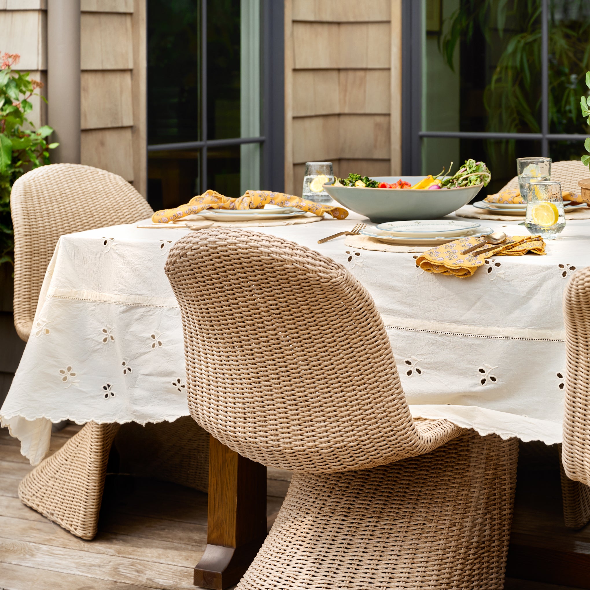 Antique White Eyelet Tablecloth shown on table outside