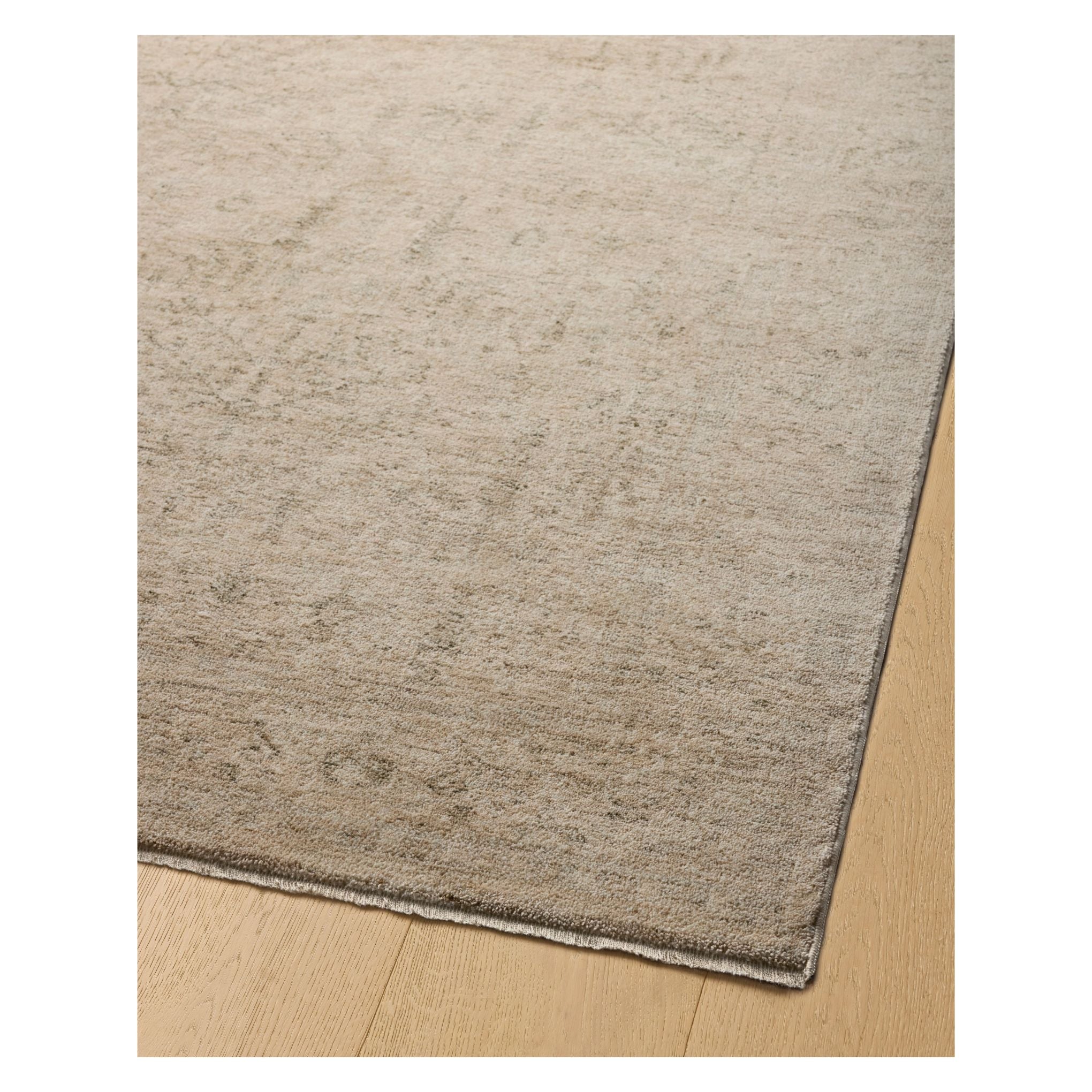 Junie Oatmeal Smoke Rug corner shown from a certain viewing angle