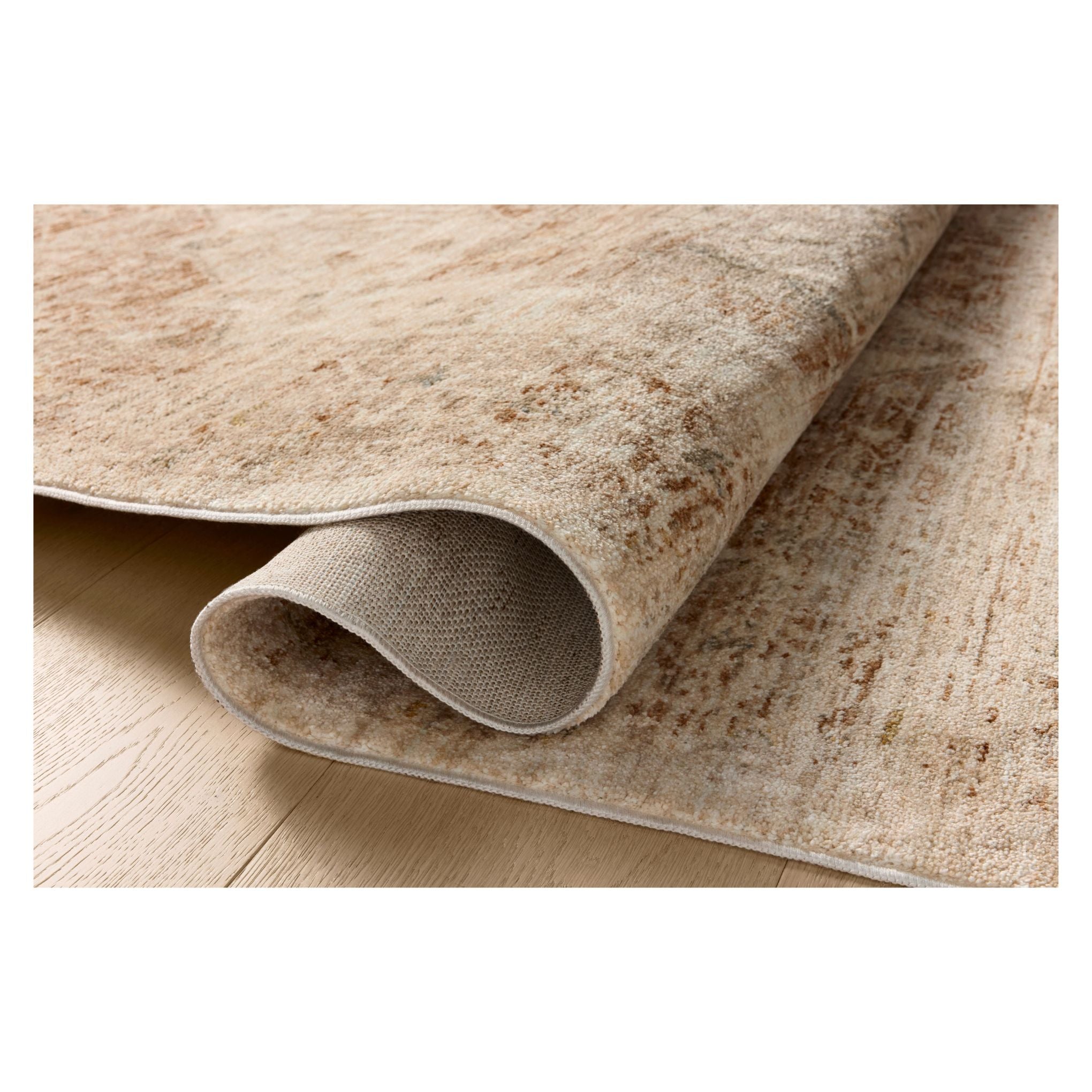 Junie Natural Clay Rug shown rolled over itself