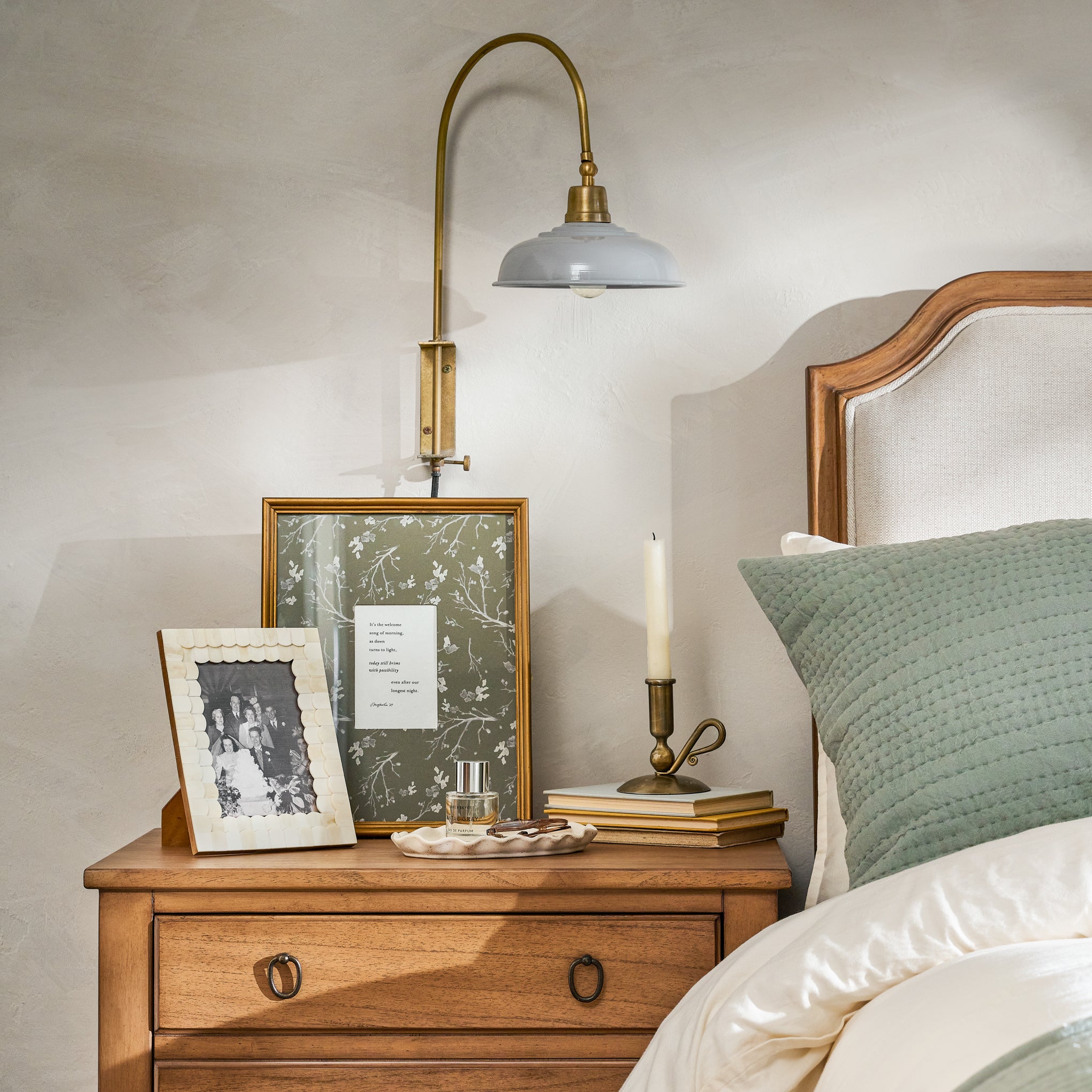 Sybil Enamel Plug-in Sconce next to a bed