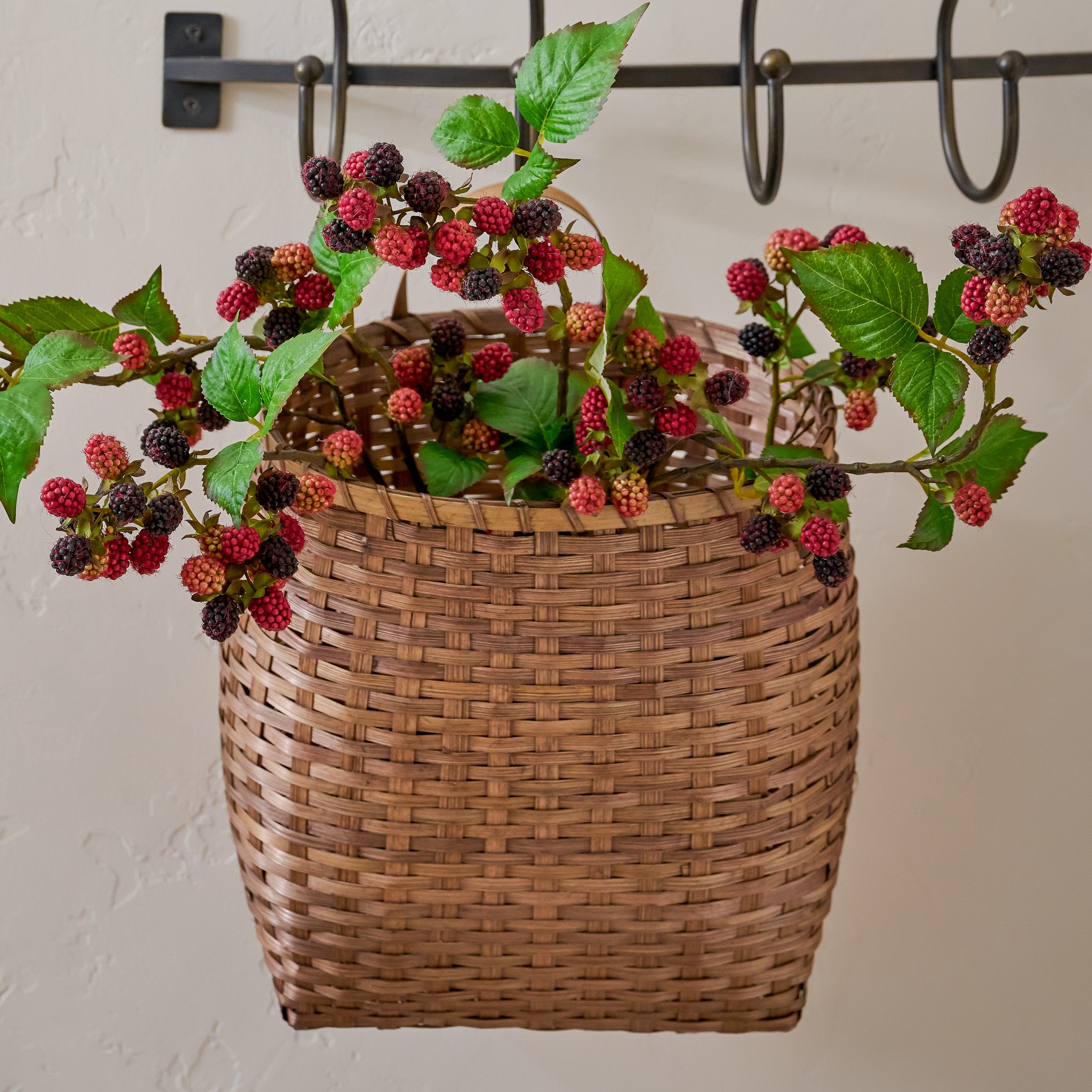 Turner Woven Wall Basket shown styled with seasonal stems