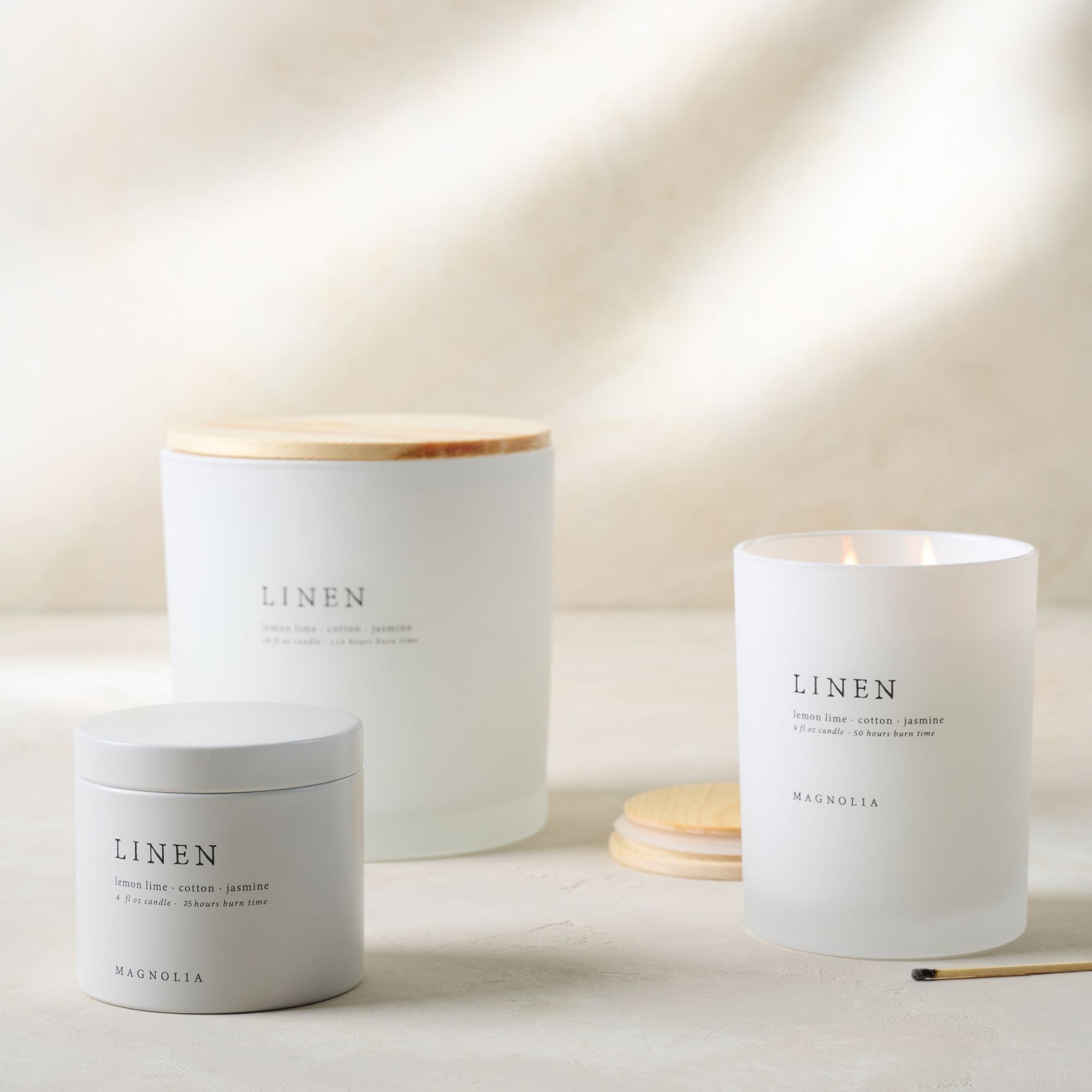 Magnoliass linen candles of various sizes grouped 